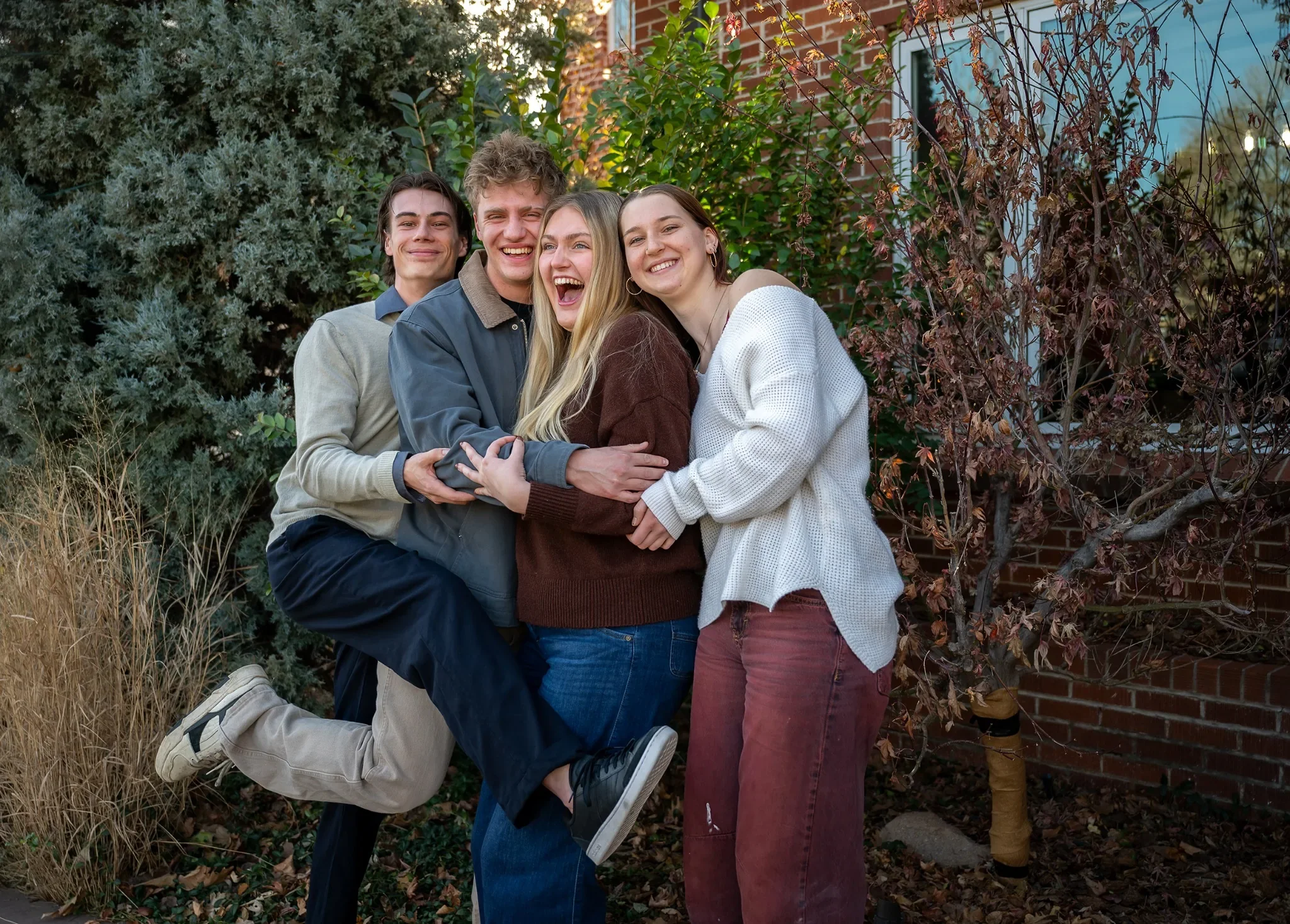 Silly teenagers family portrat at home in Denver, Colorado. Ryan Kost Photography
