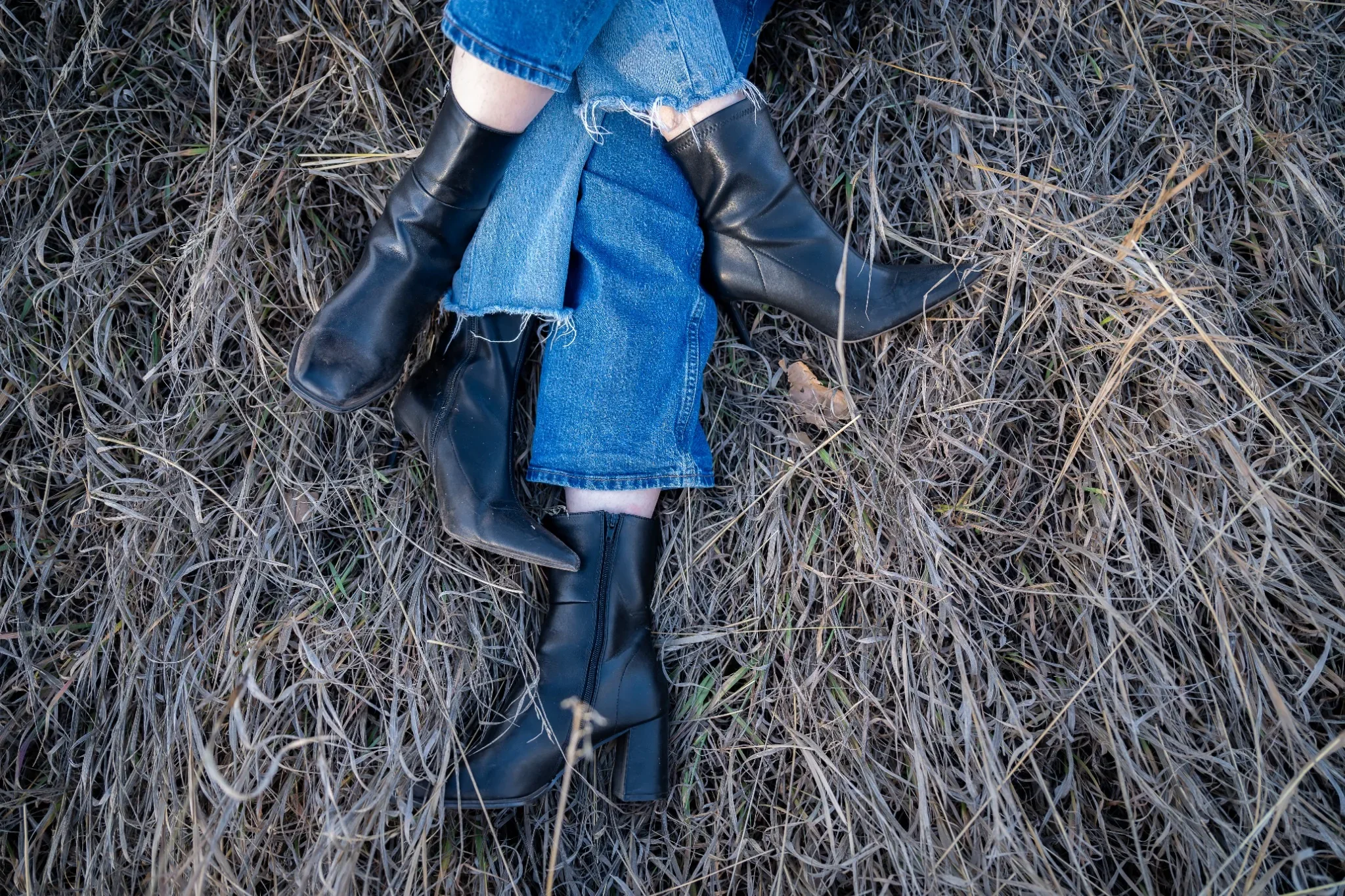 Detail photo of crossed legs and boots during a candid family photo session at South Valley Park in Littleton, Colorado