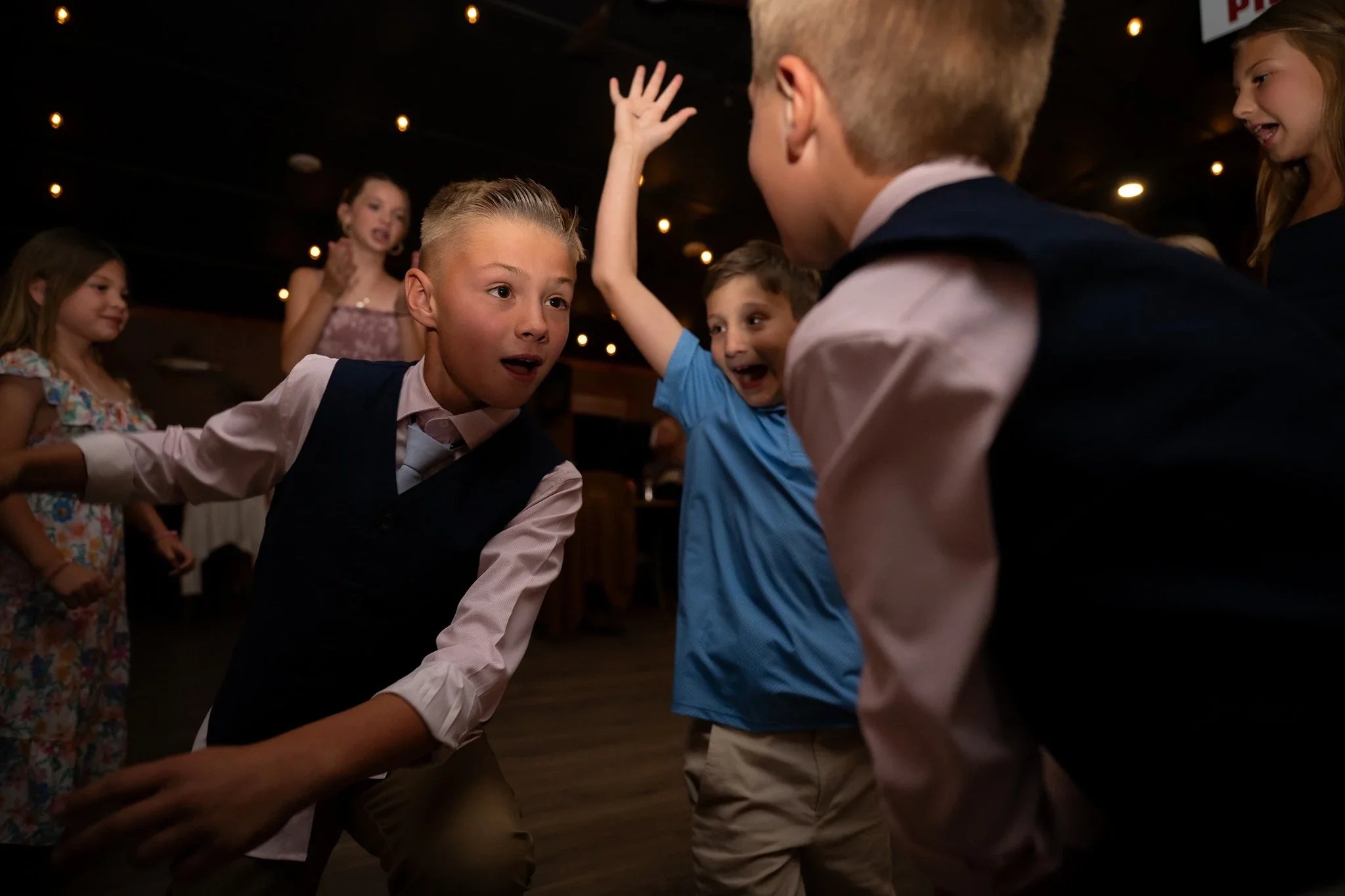 Siblings dancing the night away at the Red Bear Haus in Horca, Colorado. Wedding Photography captured by Ryan Kost.