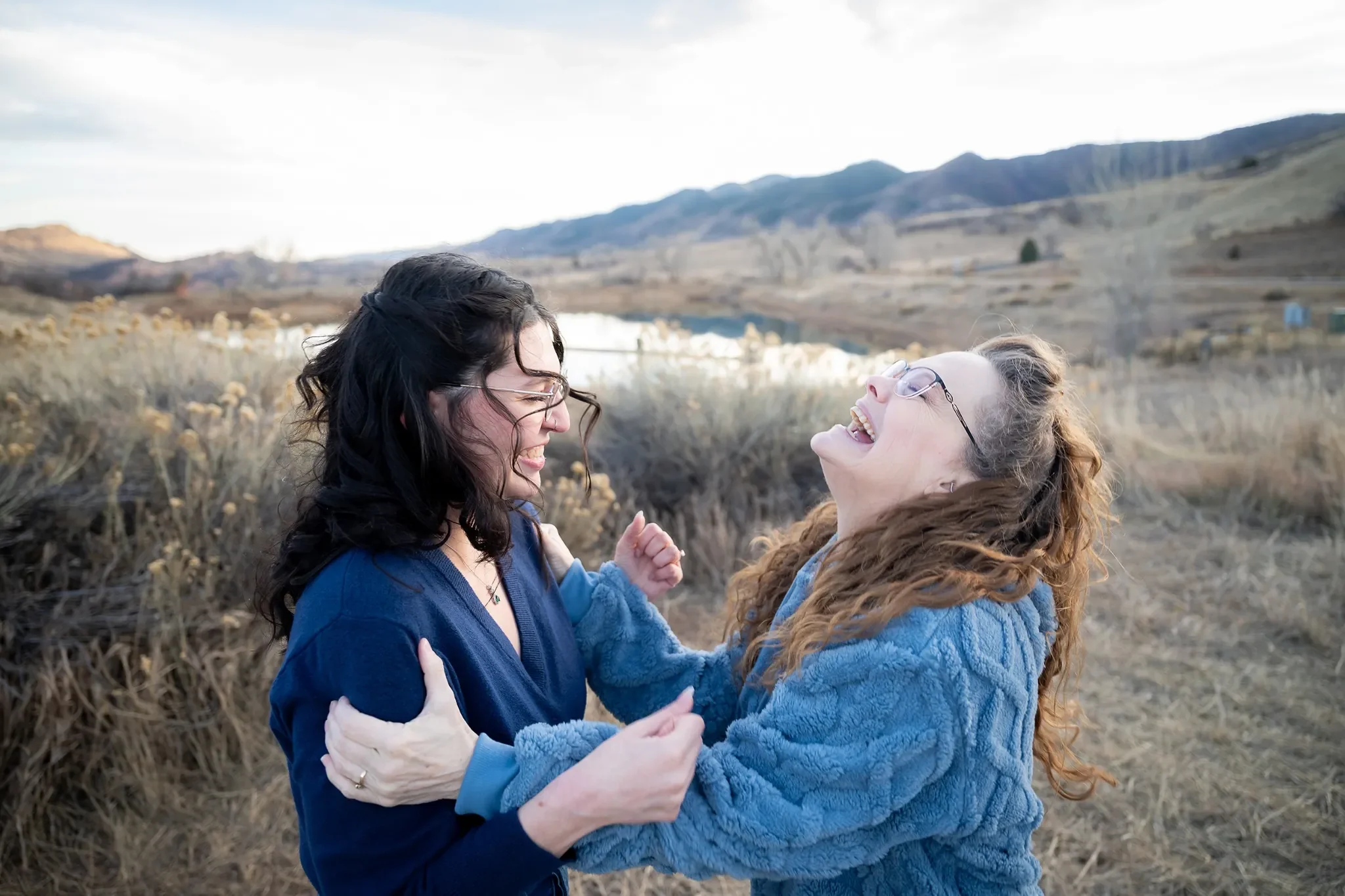 Mom shares a raw, emotional moment of joy with her new daughter-in-law to be after her son proposed. Engagement photo sesion at South Valley Park in Littleton, Colorado captured by Ryan Kost
