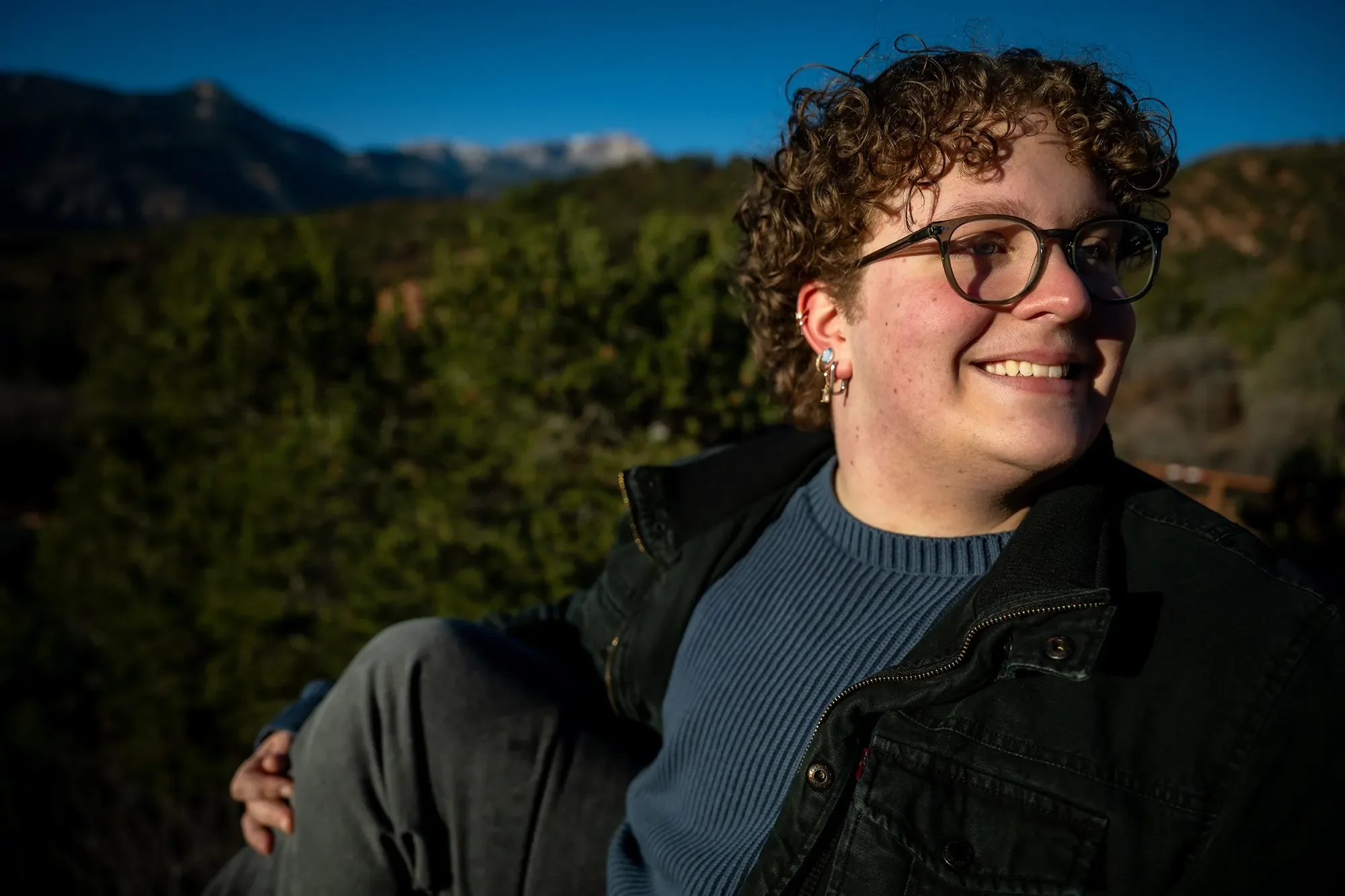 Smiling senior portrait at Garden of the Gods  during a senior portrait session captured by Ryan Kost.