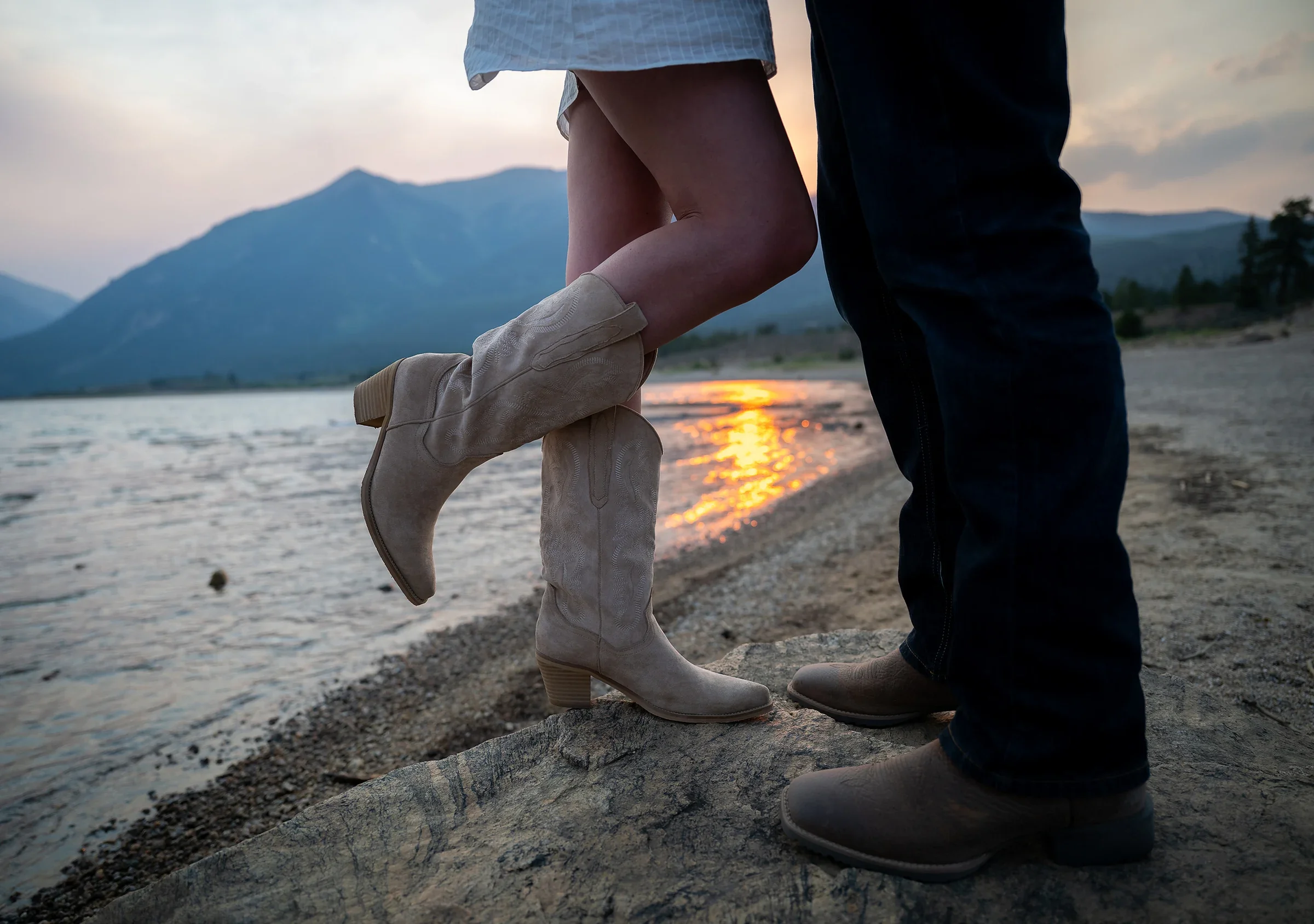 Cowgirl and cowboy boots on the shoreline at sunset during an elopement at Twin Lakes in Colorado