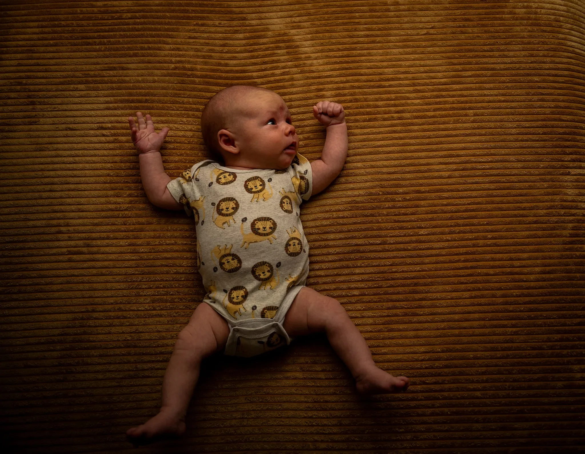Kellen, our 1-month newborn son performing jumping jacks on our couch at home in Arvada, Colorado. Ryan Kost Photography