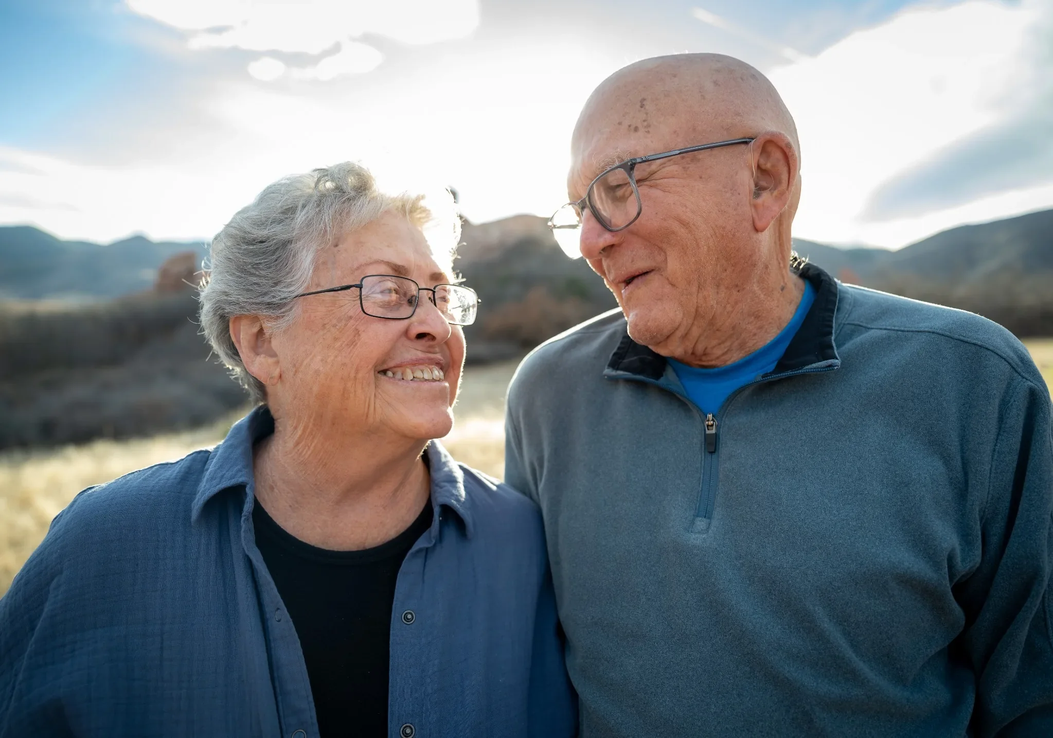 Loving looks remembering their first date many years ago.  Natural family photography captured at South Valley Park in Littleton, Colorado captured by Ryan Kost.