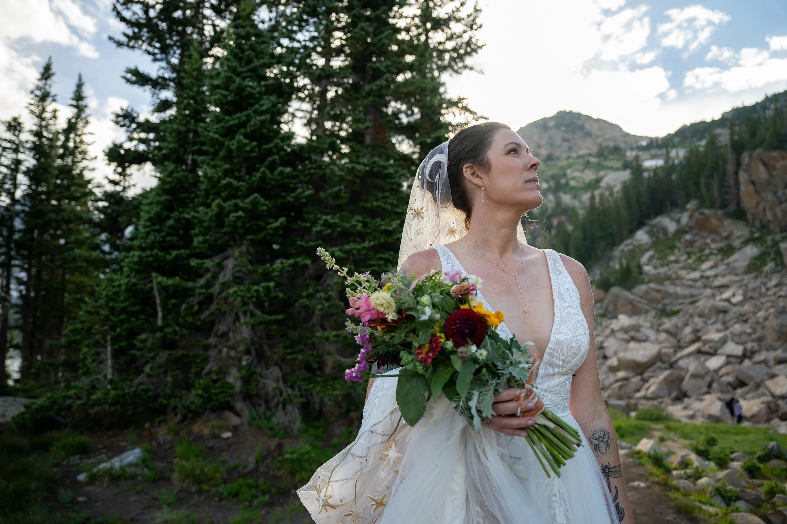 Bride takes a moment and deep breath before walking the trail to meet her groom. Lake Isabelle elopement photography captured naturally by Ryan Kost