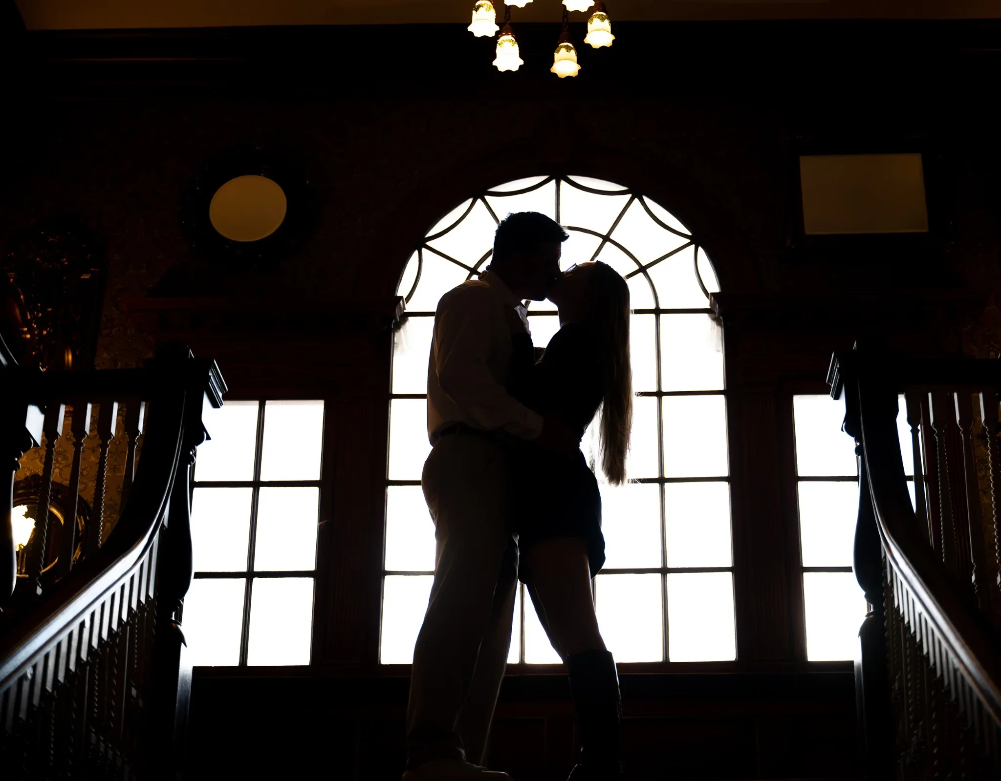 Cinematic silhouette of an engaged couple inside the historic Stanley Hotel in Estes Park