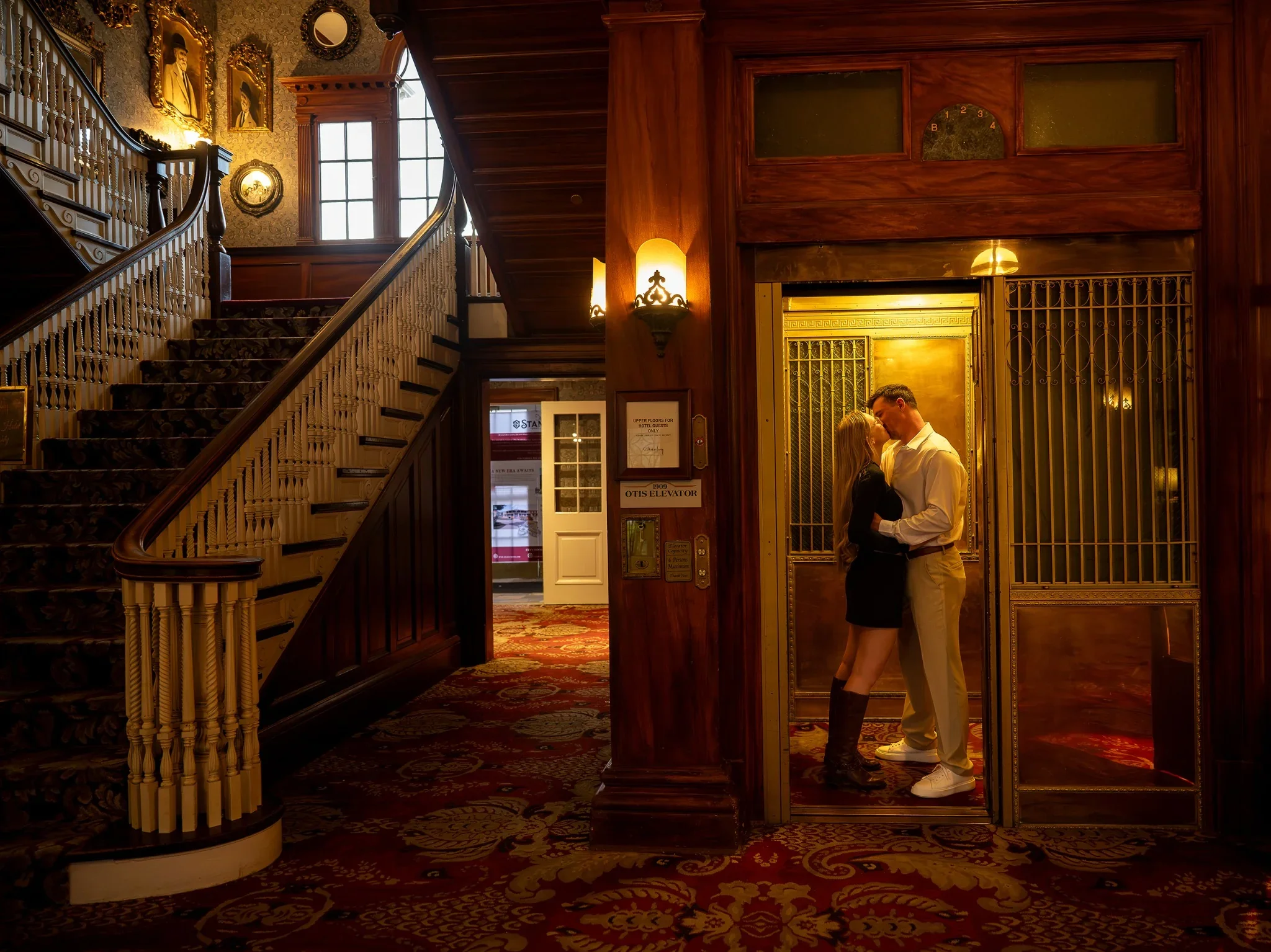 A cinematic engagement portrait in the elevator inside the historic Stanley Hotel in Estes Park, Colorado captured by Ryan Kost.