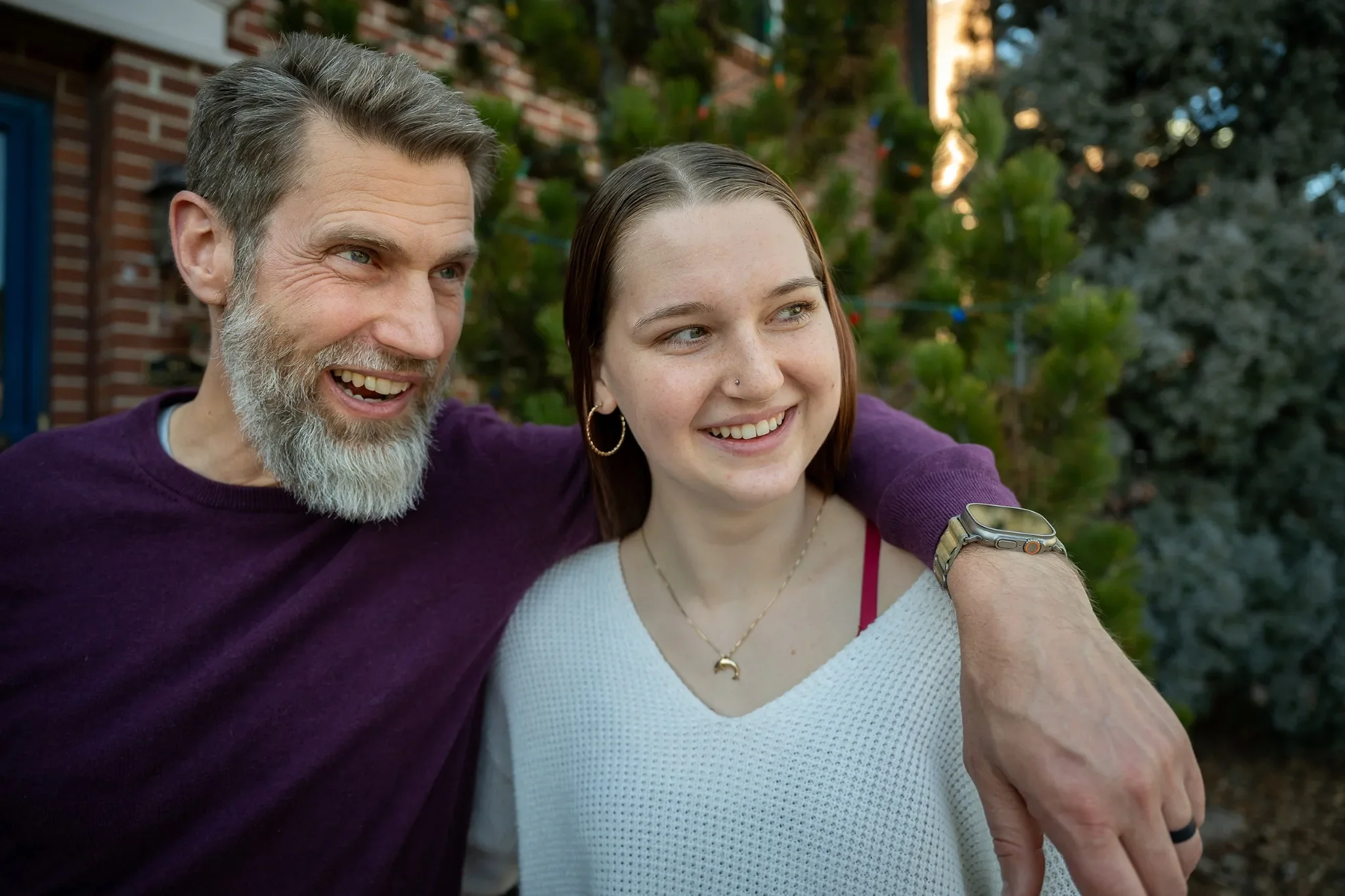 Dad and daughter natural loving family portrait in front of home in Denver, Colorado captured by Ryan Kost