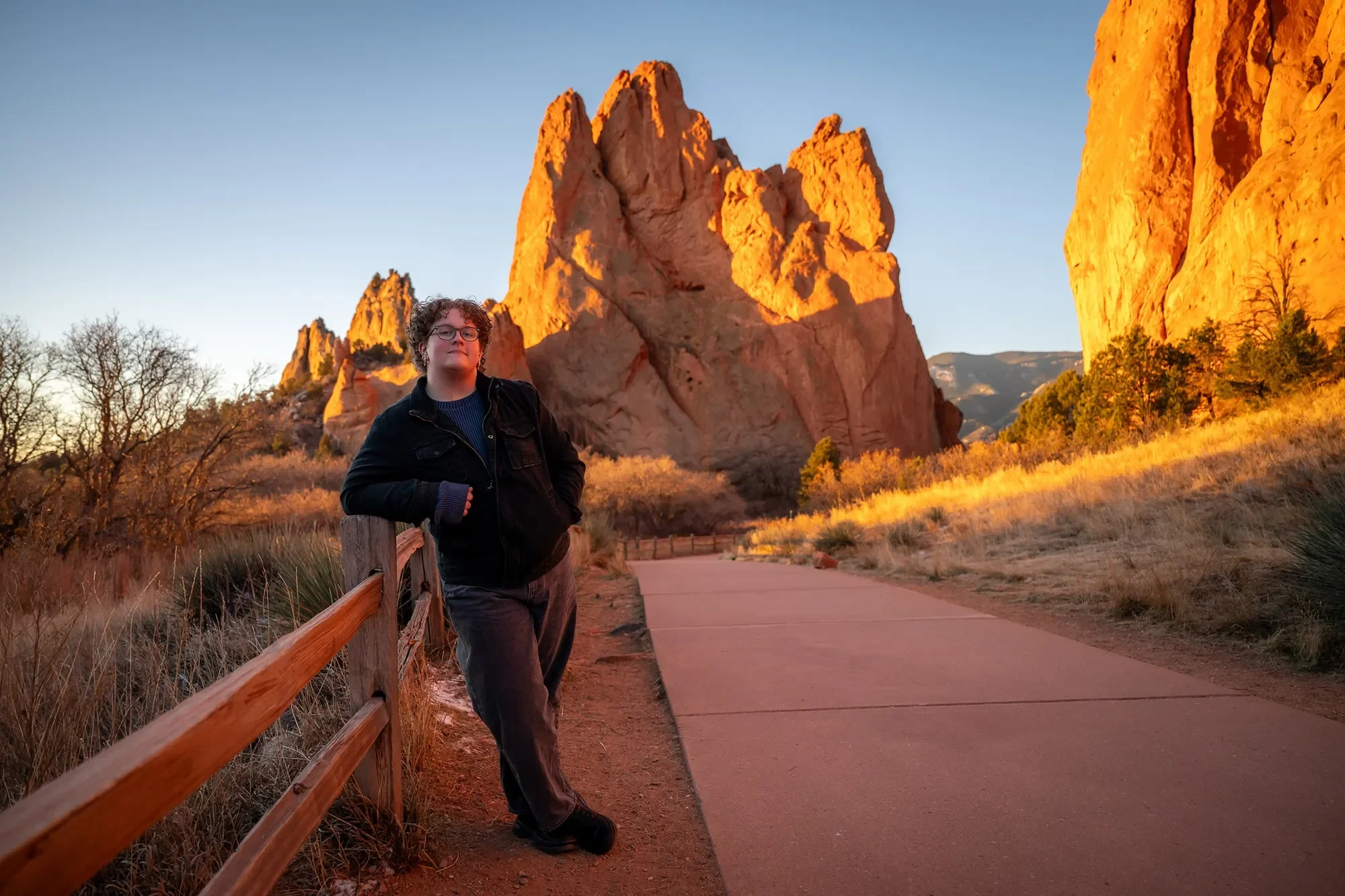 Relaxed, natural graduating high school senior portrait captured at sunrise at Garden of the Gods in Colorado Springs by Ryan Kost Photography