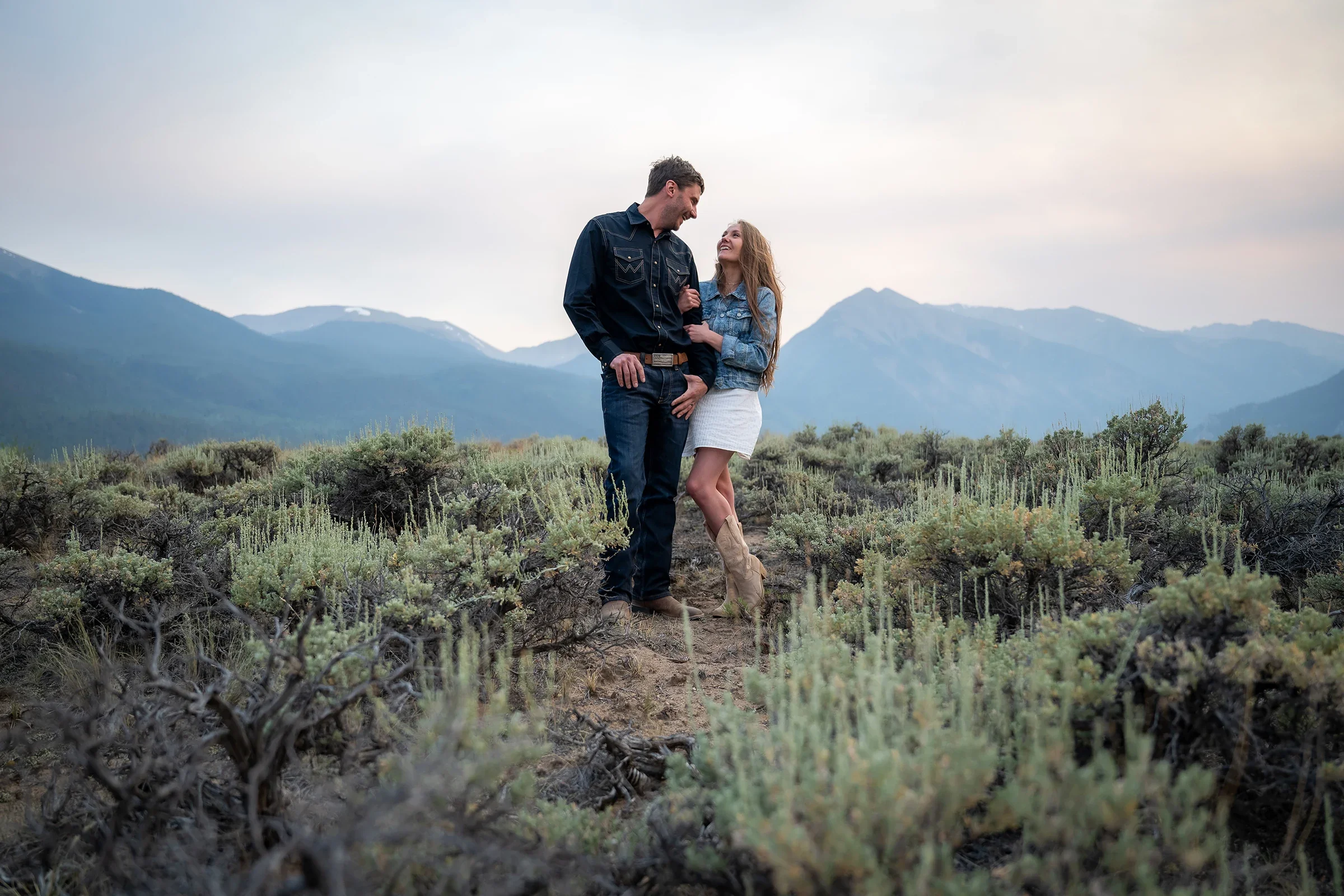 Couple embracing in the sagebrush during their summer elopement at Twin Lakes, Colorado.