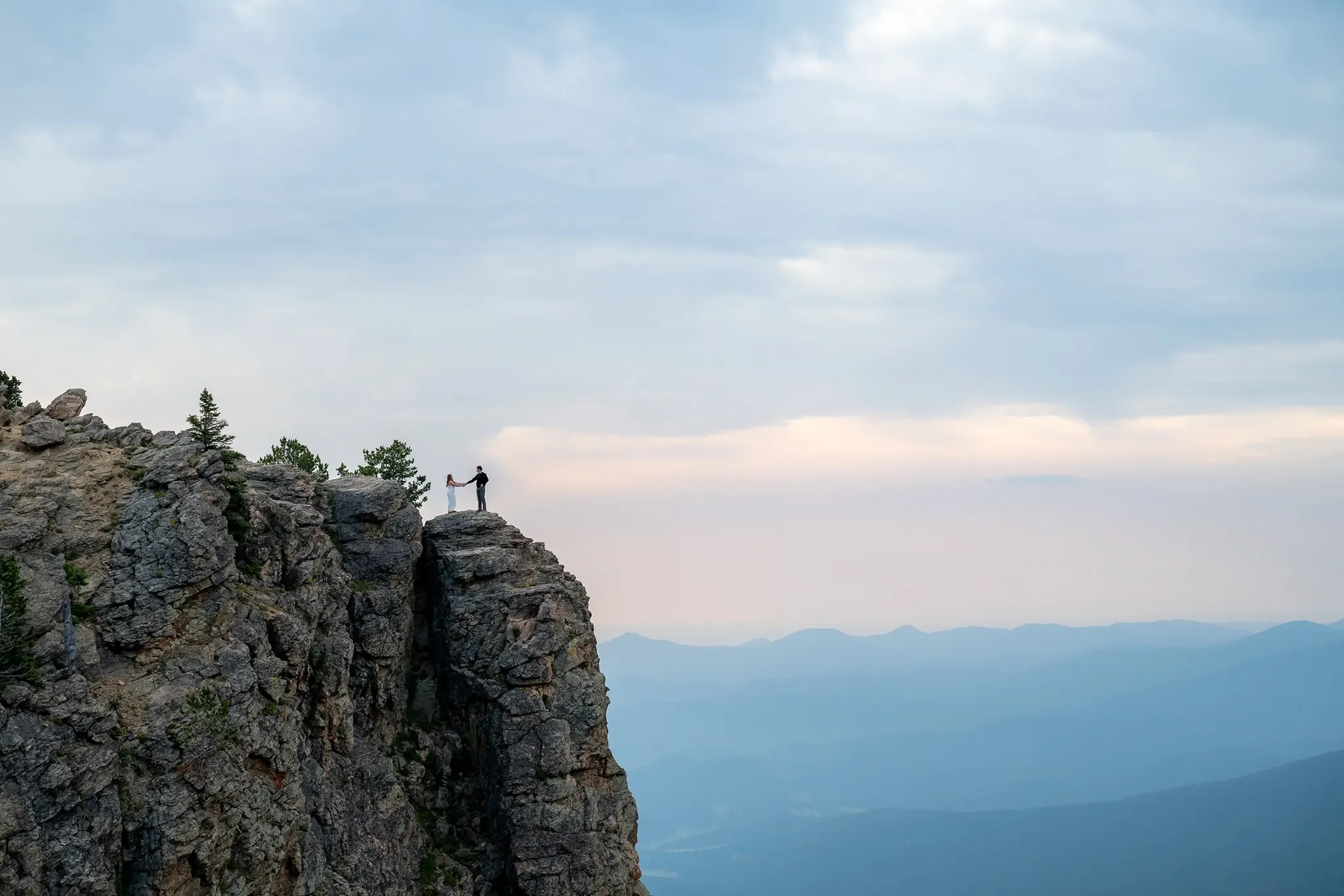 Dramatic engagement photoshoot atop Juniper Pass cliffs in the Colorado Rocky Mountains. Captured by Denver elopement and wedding photographer Ryan Kost