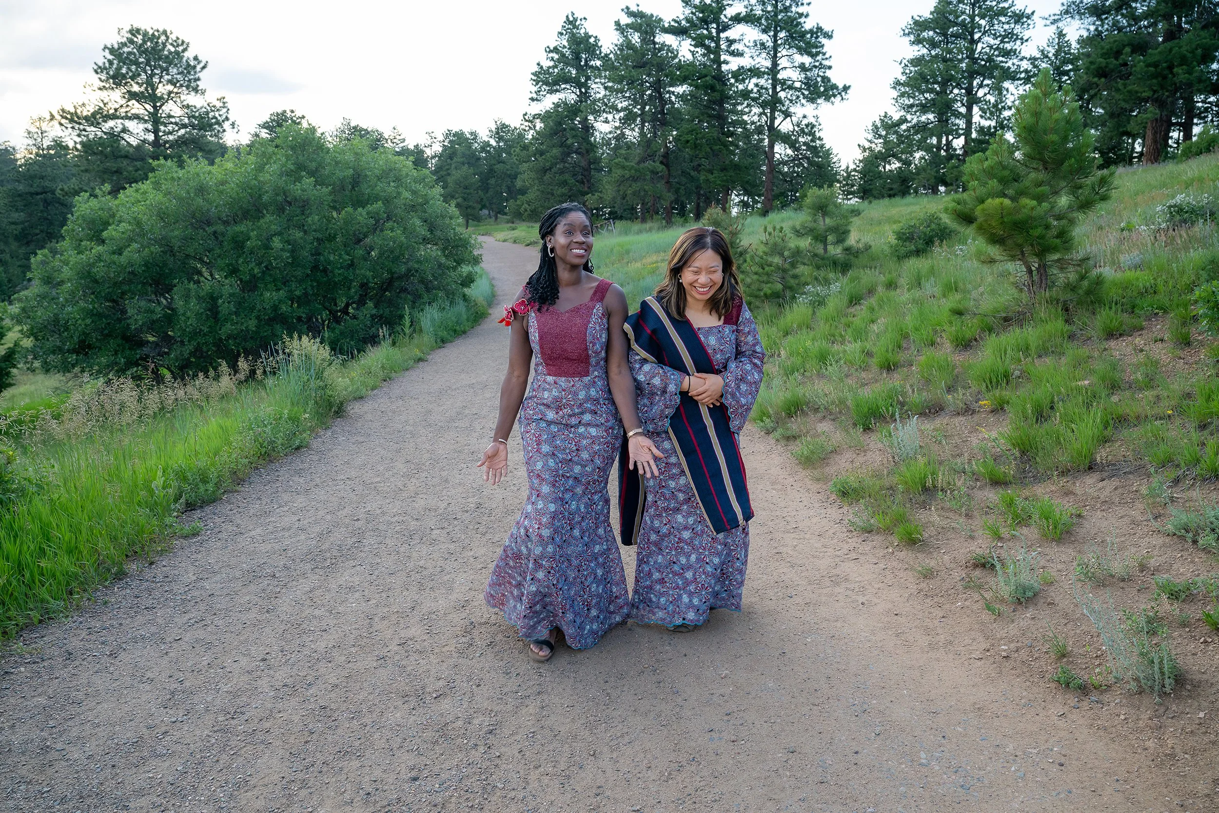 Natural family moments of sisters in law in conversation walking trail at Mount Falcon West in Indian Hills, Colorado. Captured by Denver family photographer Ryan Kost