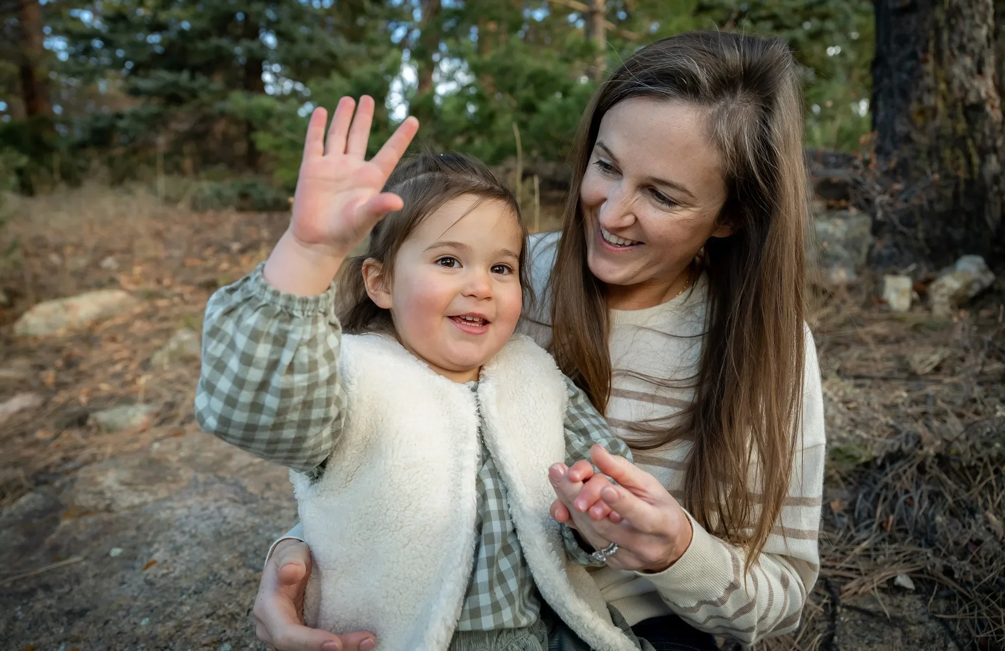 Mom and daughter intimate portrait singing baby shark during a family photo session in Indian Hills, Colorado