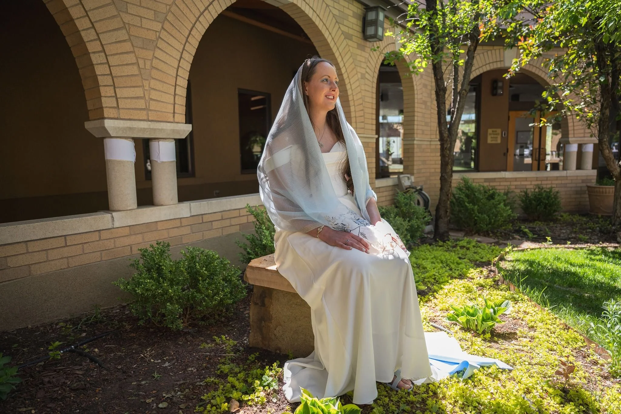 Bride posing outside of chapel. Artful storytelling through the lens—intimate elopement portraits from Spirit of Christ Church in Arvada with a beautiful balance of drama and love by Ryan Kost.