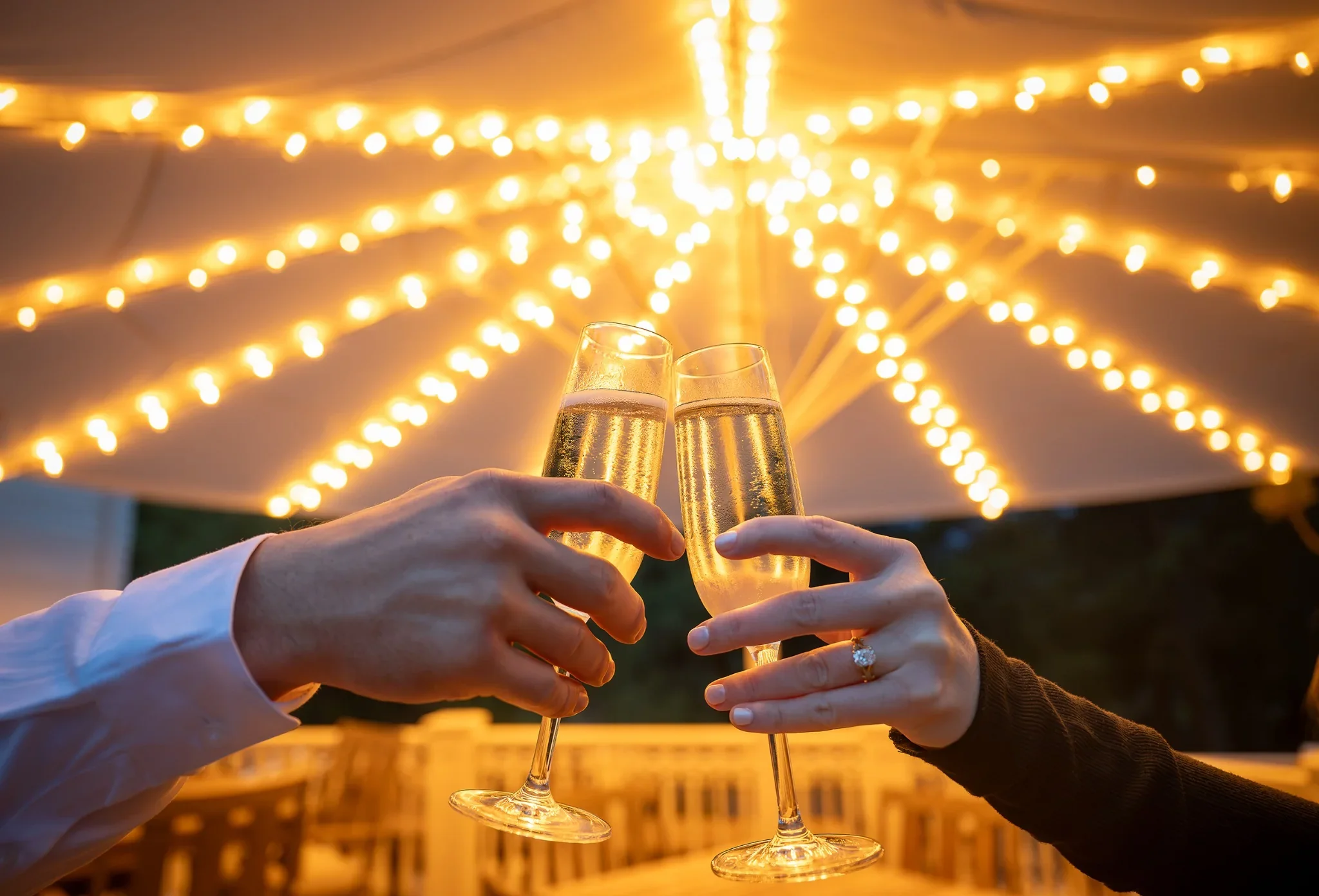 Couple celebrating their Stanley Hotel engagement with champagne in Estes Park