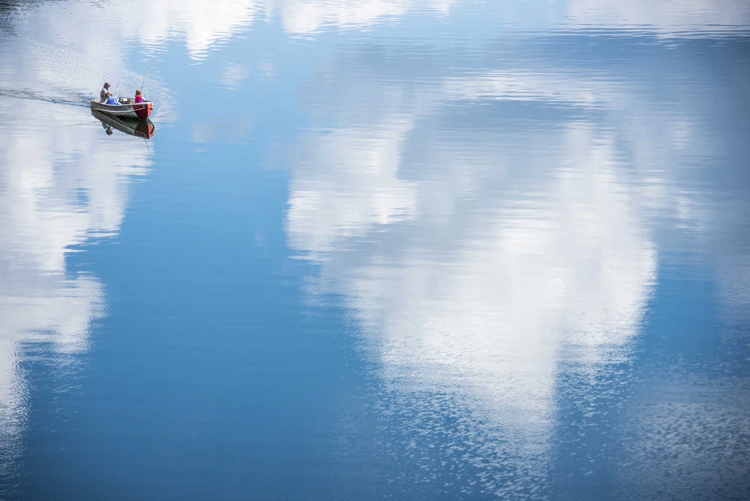 Fishing for clouds. Natural family photography while out fishing on Taylor Park Reservoir in the Colorado Rocky Mountains captured by Ryan Kost.
