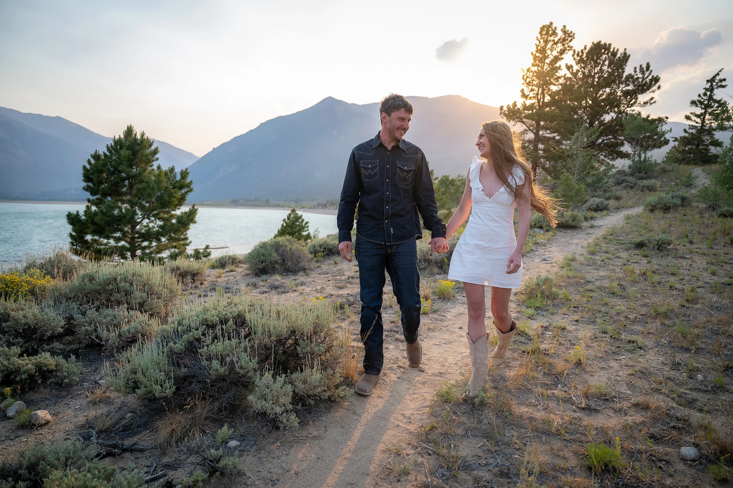 Newlywed couple walking together through the mountain landscape during their Twin Lakes elopement.