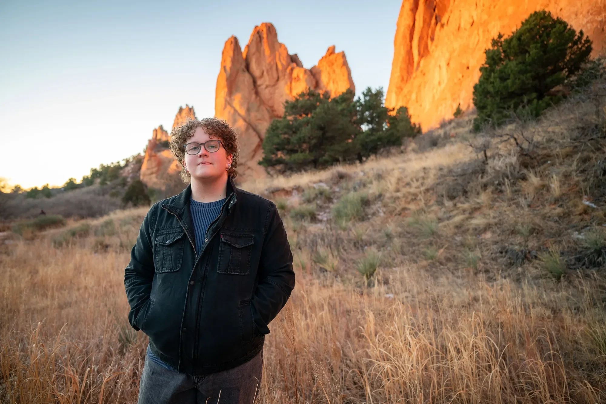 Gently posed high school senior portrait during sunrise at Garden of the Gods. Ryan Kost Photography