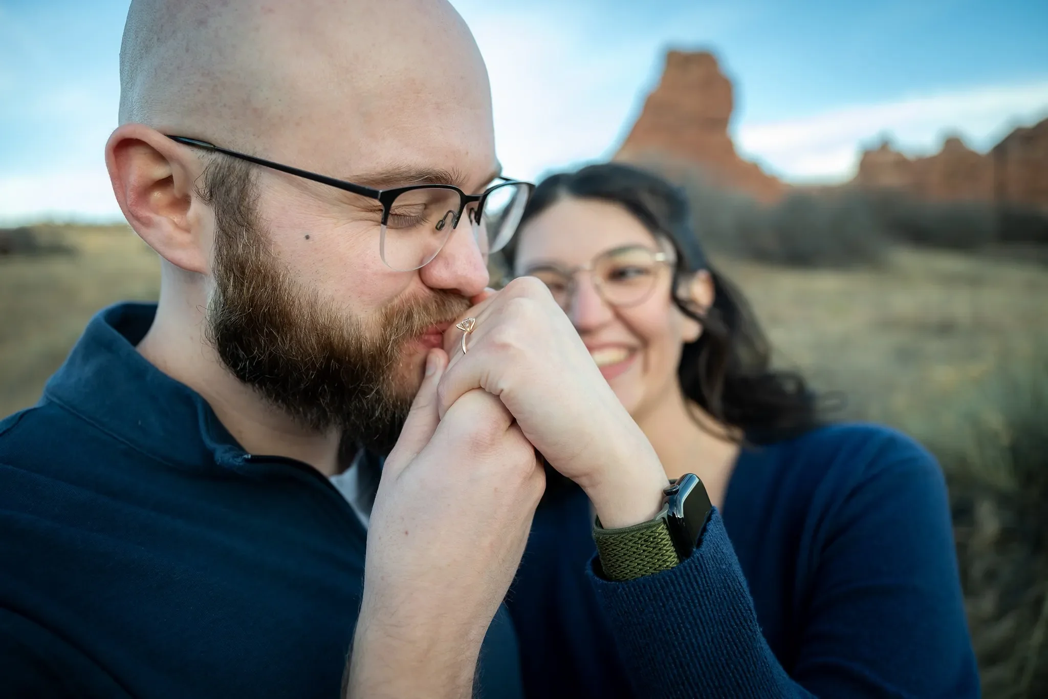 Intimate moment at South Valley Park in Littleton, Colorado, as  recently engaged couple shares a joyful moment after proposal photographed by Ryan Kost