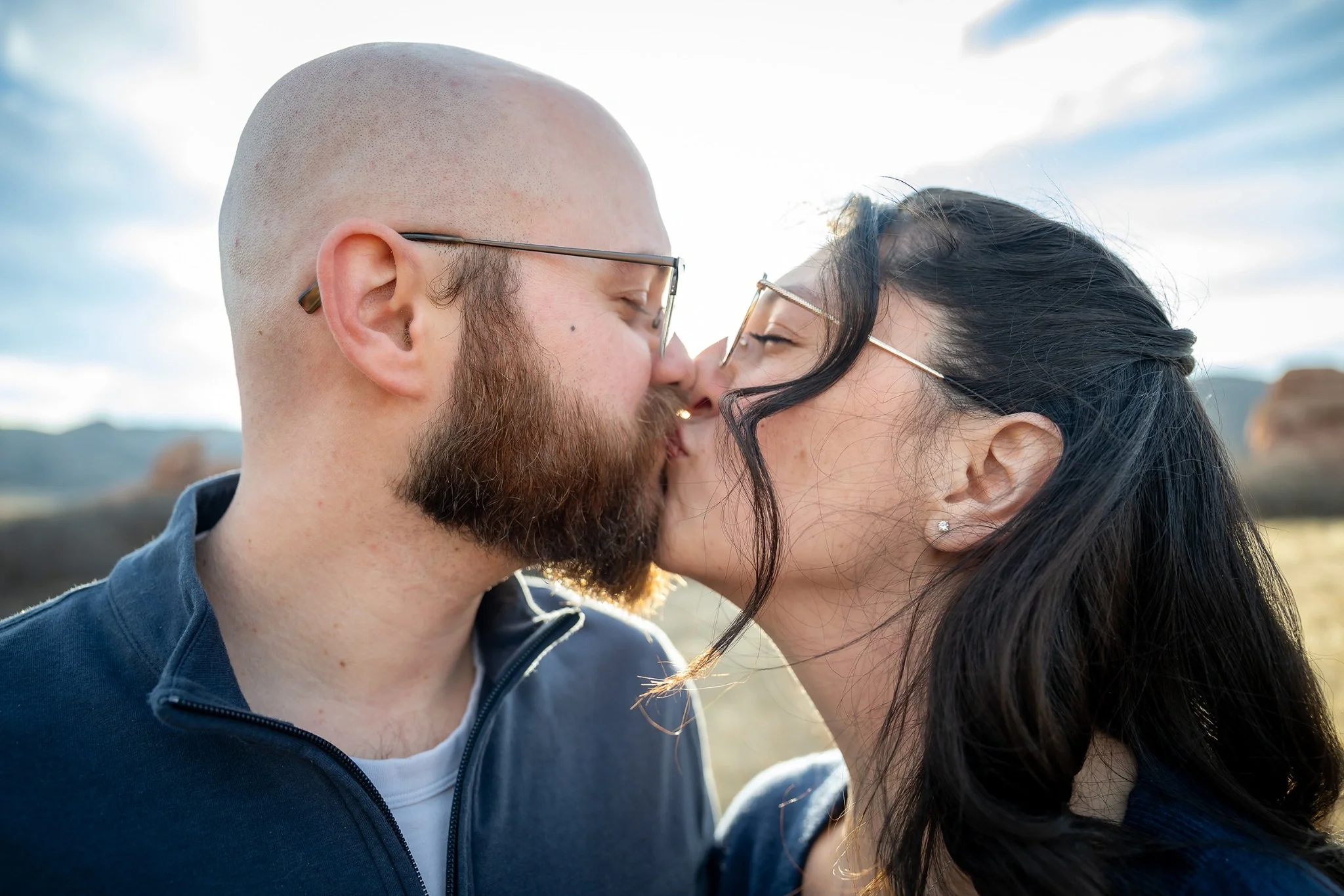Couple shares a kiss moments after getting engaged at South Valley Park in Littleton, Colorado captured by Ryan Kost