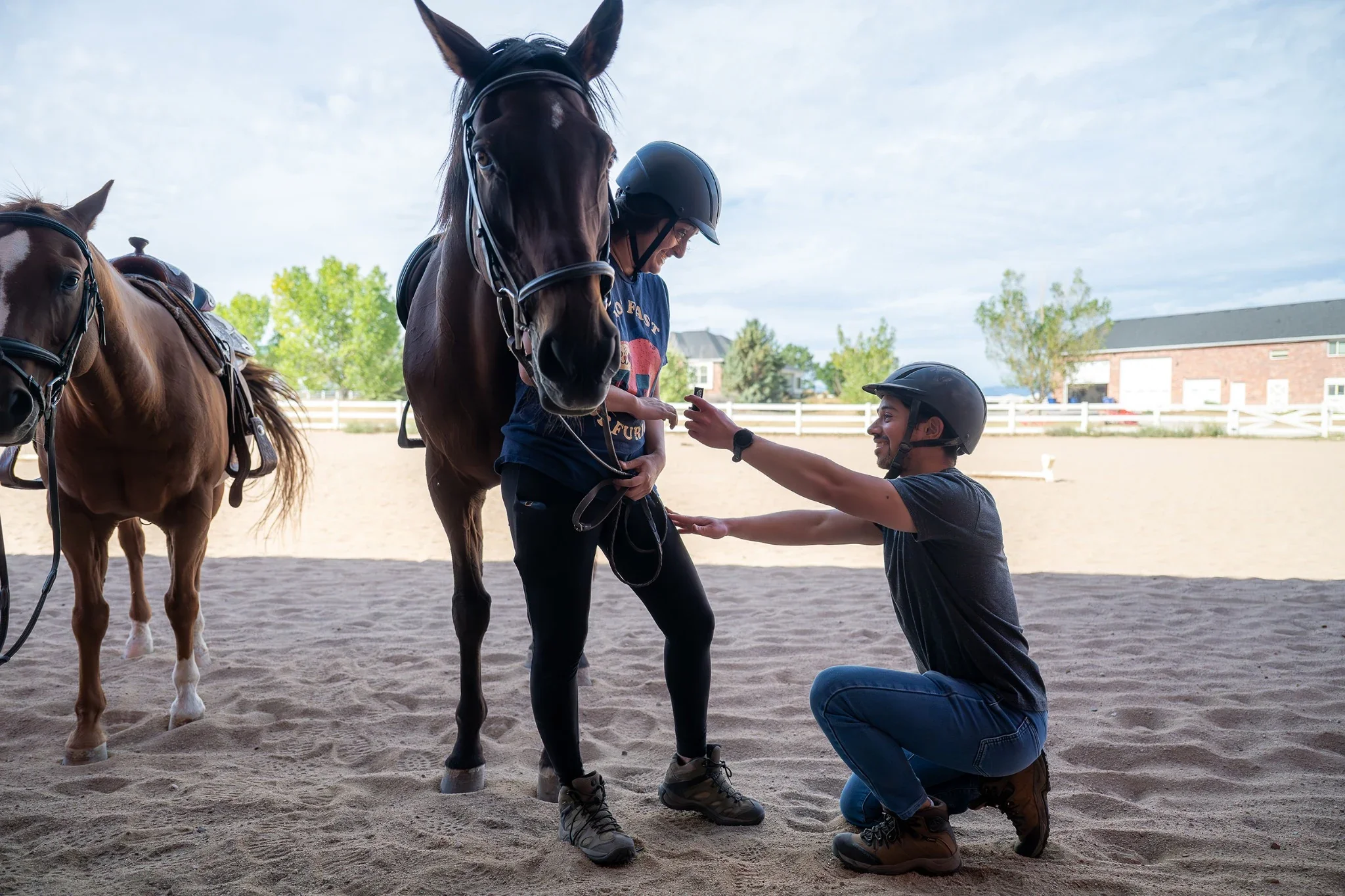 A surprise engagement proposal at Morelli Ranch after horse lessons in Brighton, Colorado captured naturally by Ryan Kost.