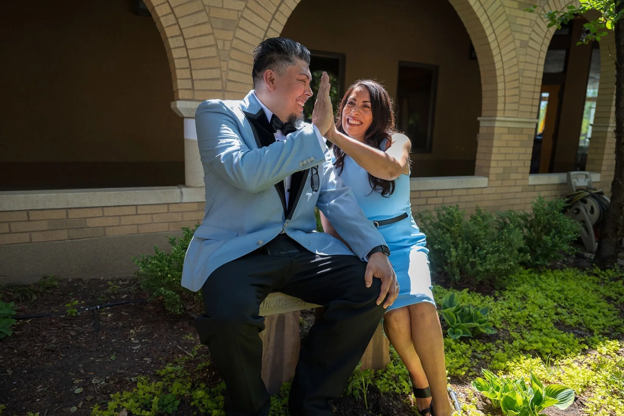 High five between sister and groom. Artful storytelling through the lens—intimate elopement portraits from Spirit of Christ Church in Arvada with a beautiful balance of drama and love by Ryan Kost.