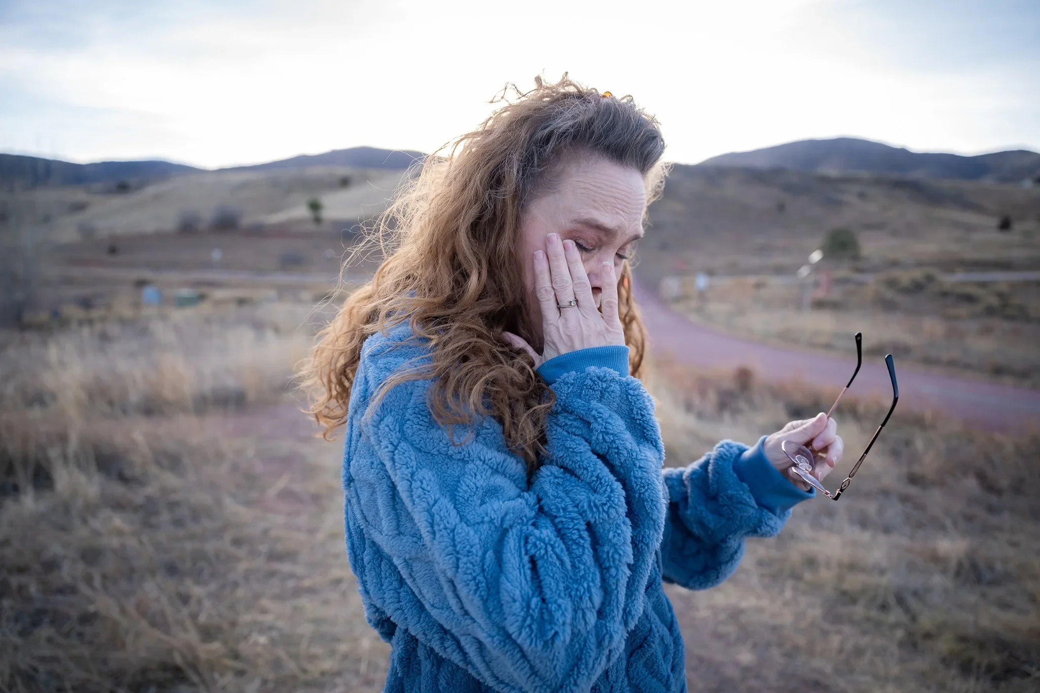 Mom has an emotional moment after her son proposed to his girlfriend during a surprise engagement photo session at South Valley Park in Littleton, Colroado captured by Ryan Kost