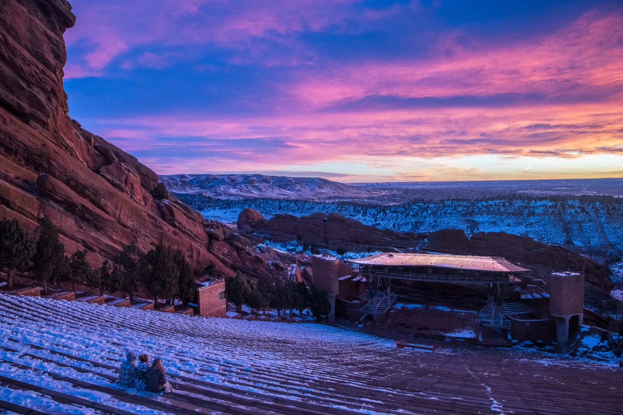 A family enjoys a beautiful winter sunrise at Red Rocks Amphitheater captured by Ryan Kost.