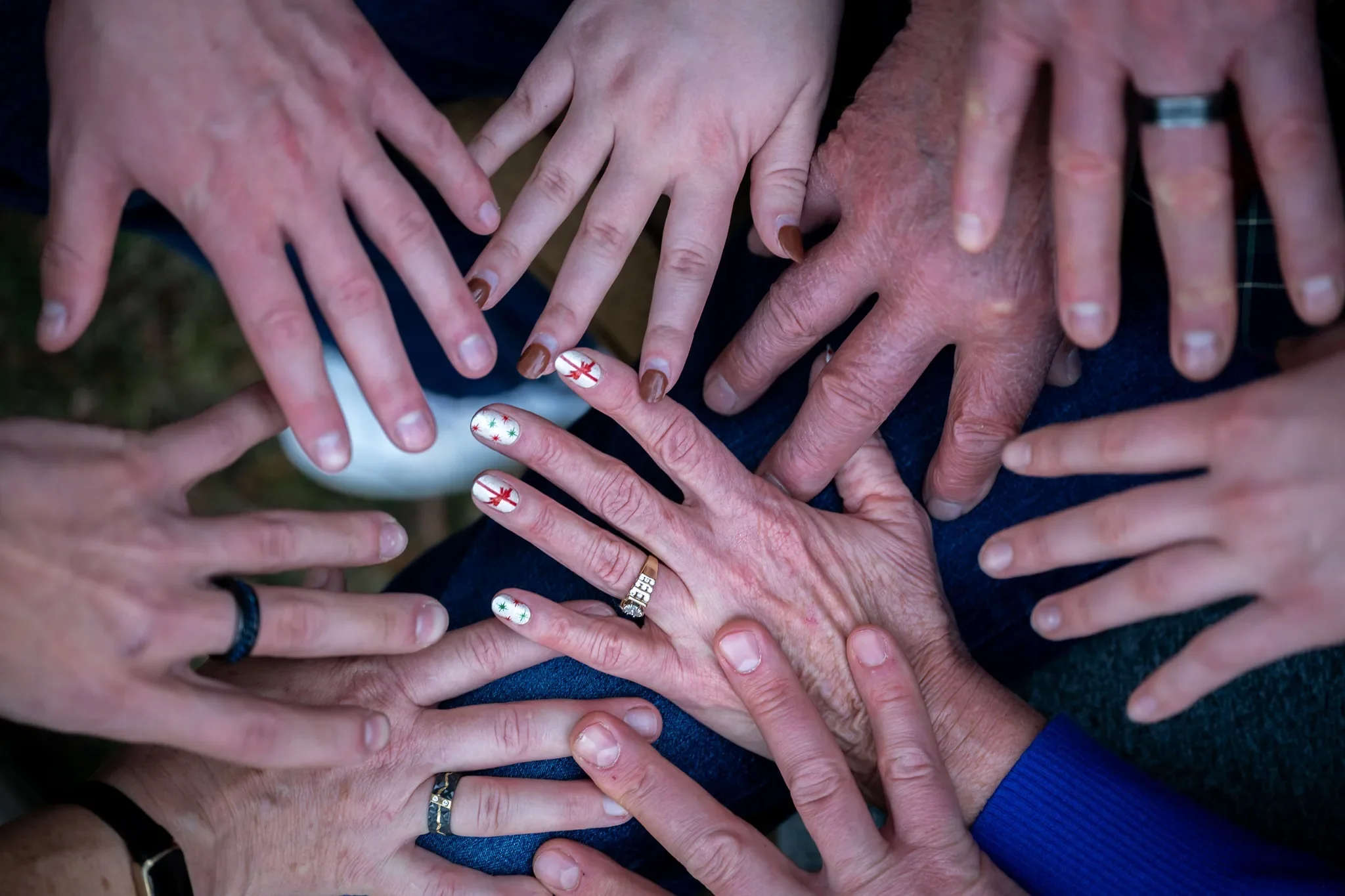 Family portrait of hands all together at in home documentary session in Denver, Colorado captured by Ryan Kost