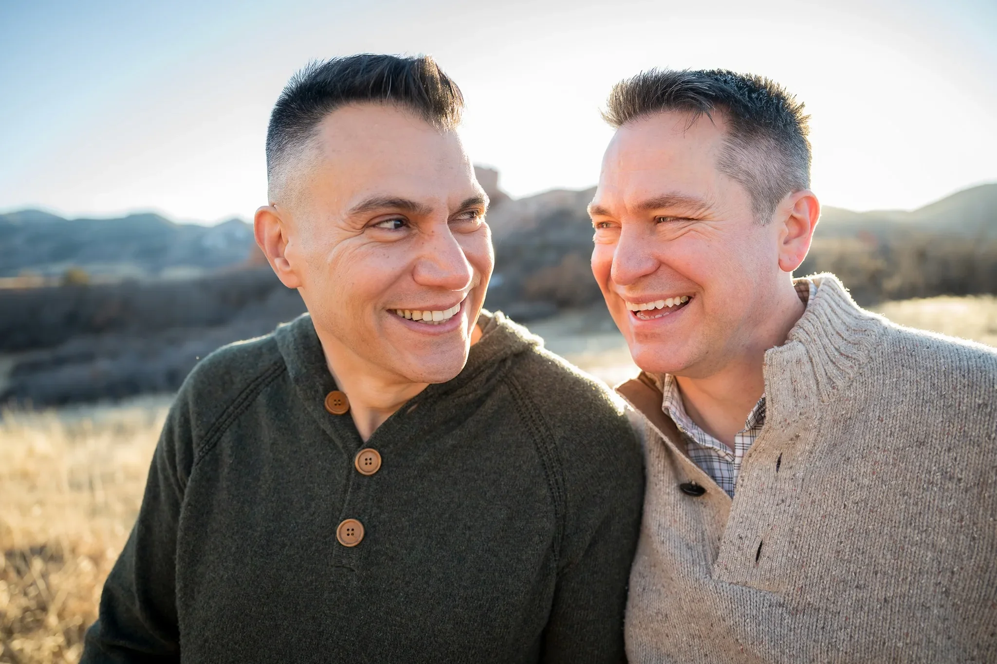 Couple giving loving looks during outdoor family photography session at South Valley Park Littleton Colorado.