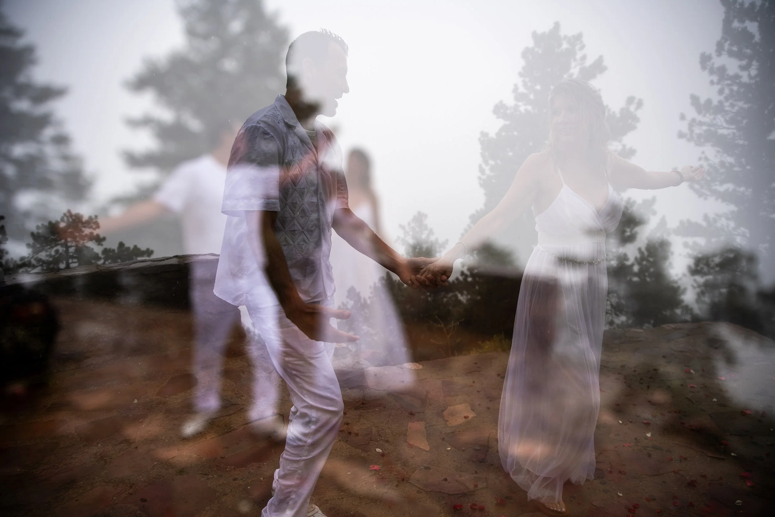 A double exposure photo of a man and woman holding hands outdoors surrounded by trees, with ghostly images of the same couple dancing and smiling.