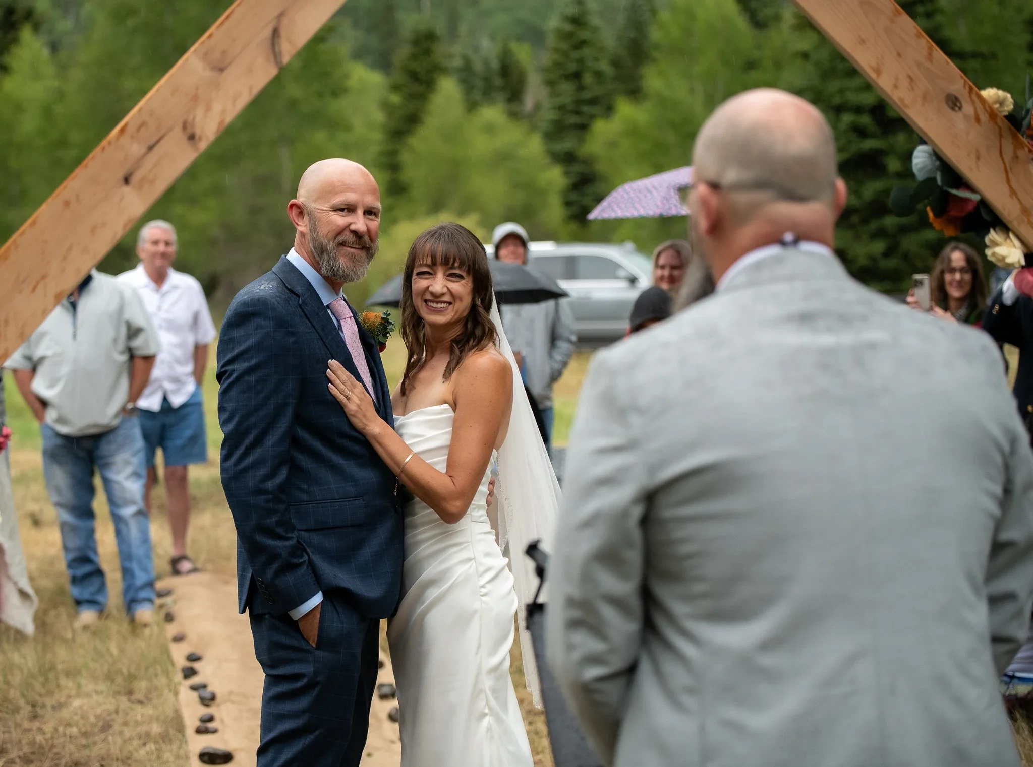 Bride and Groom during their ceremony at Spectacle Lake campground in Horca, Colorado during their intimate summer wedding.