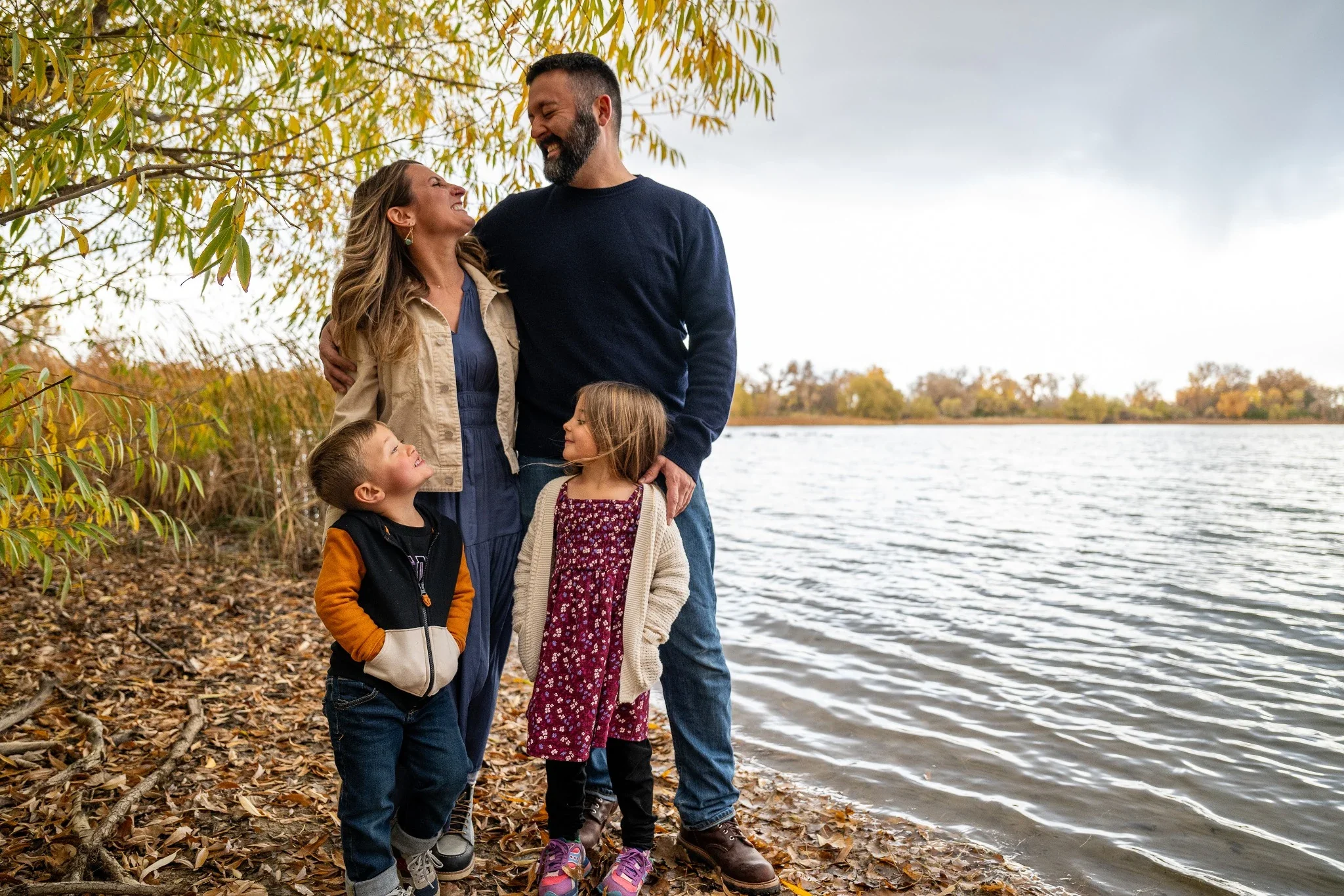 A beautiful fall family portrait at Waneka Lake in Lafayette, Colorado.  Natural, relaxed family photography captured by Denver photogapher Ryan Kost