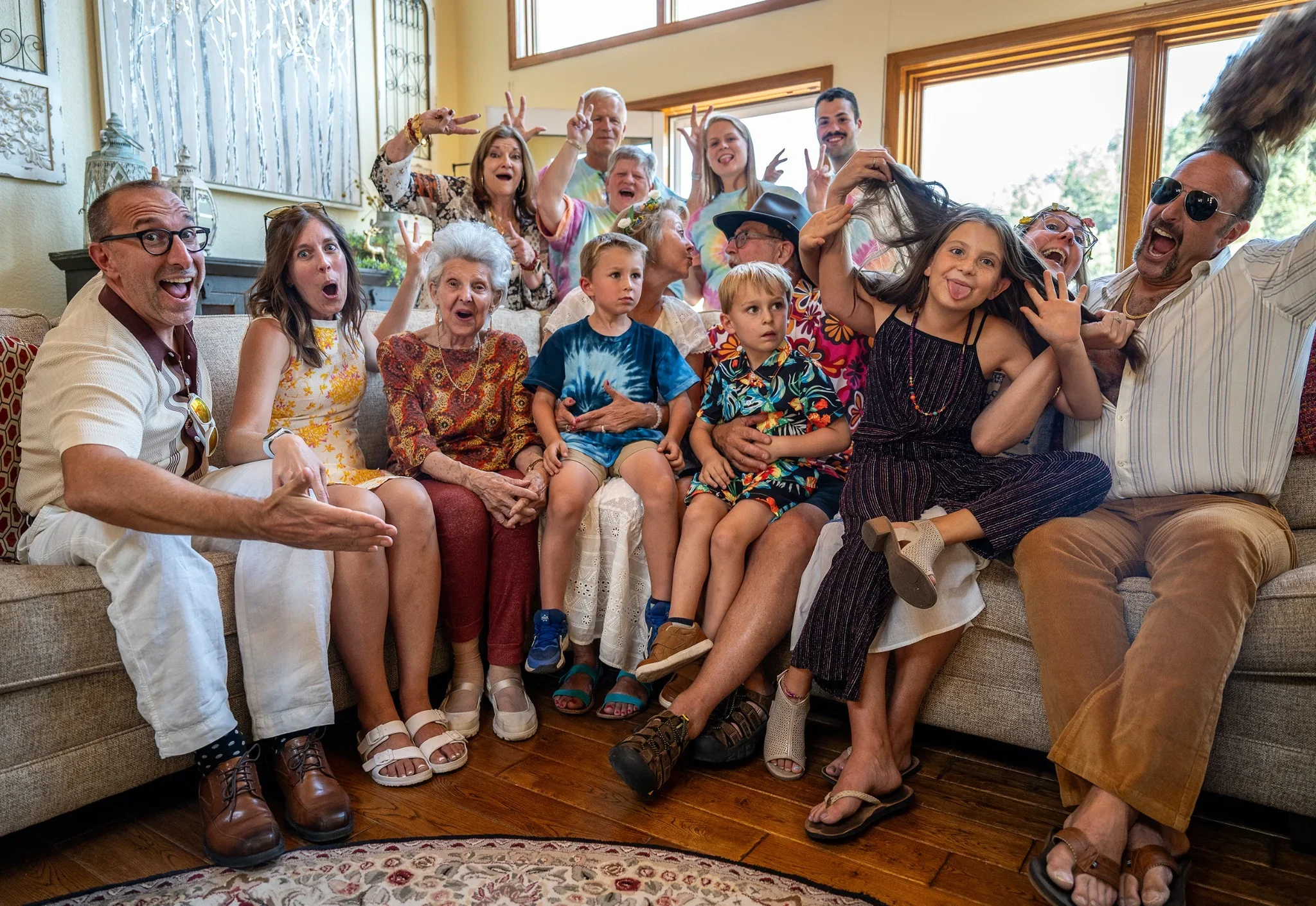 Large, fun family portrait at 70s themed 50th wedding anniversary birthday event at home in Lookout Mountain Golden, Colorado. Ryan Kost event photography