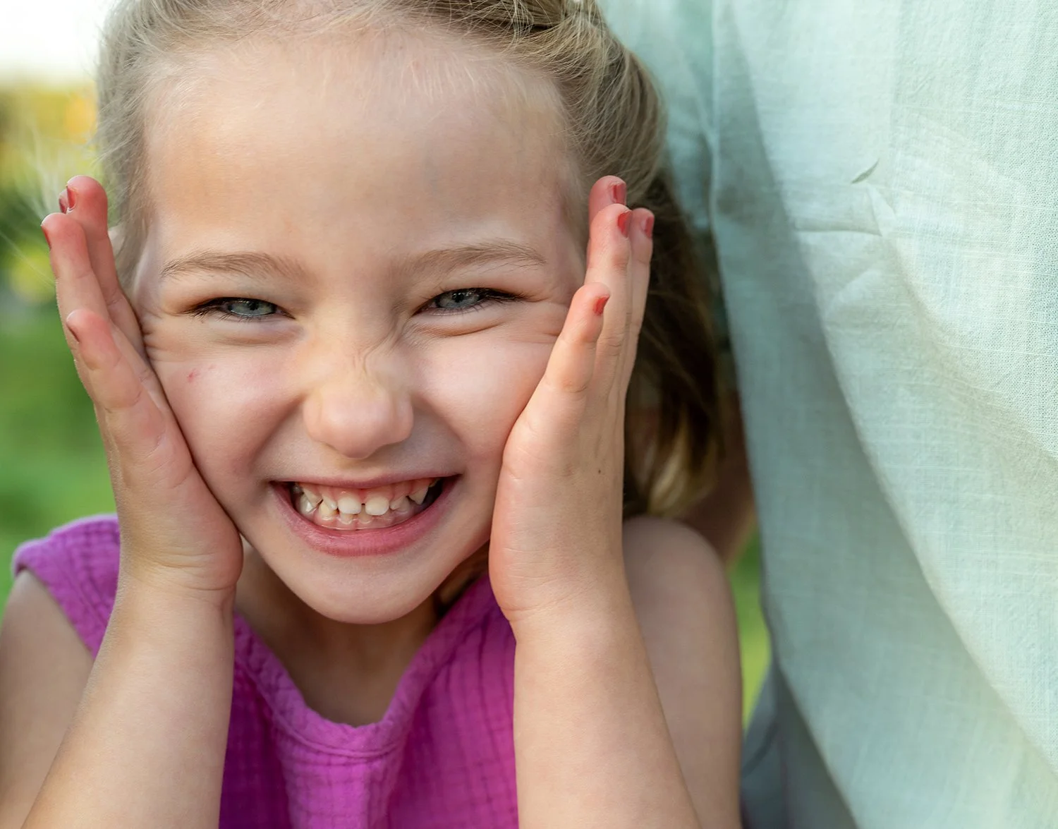 Close-up of cute young girl making faces for the camera. Real, candid moments captured by Ryan Kost at this family photshoot at Red Rock Canyon Open Spacei in Colorado Springs.