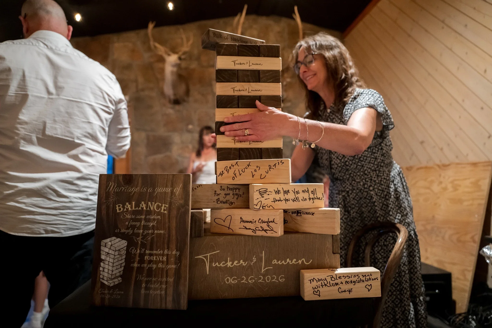 Jegna Tower with wedding attendee signatures at Red Bear Haus in Horca, Colorado. Ryan Kost Photography