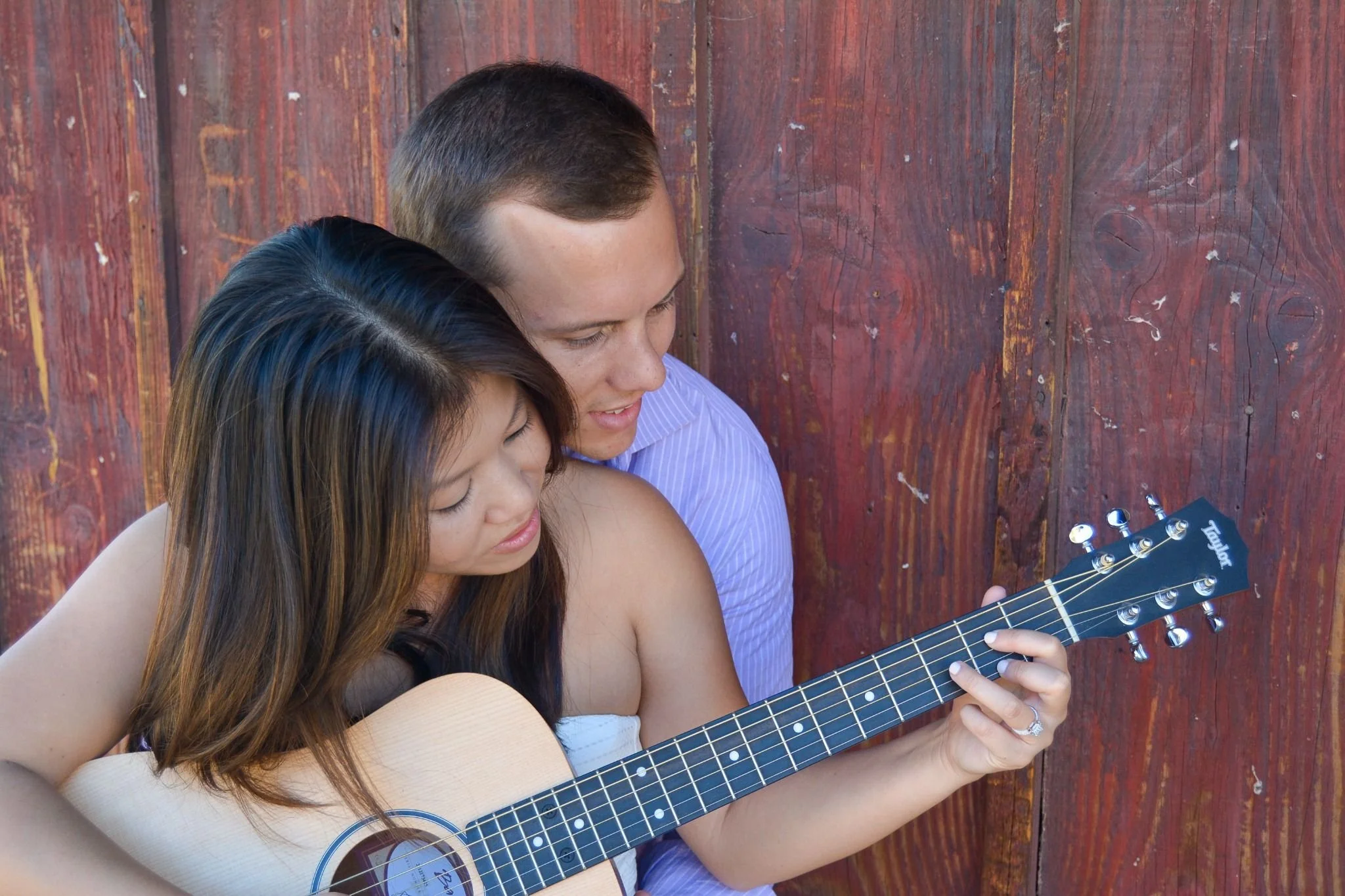 Cute couple portrait playing guitar together captured by Denver, Colorado engagement photographer Ryan Kost
