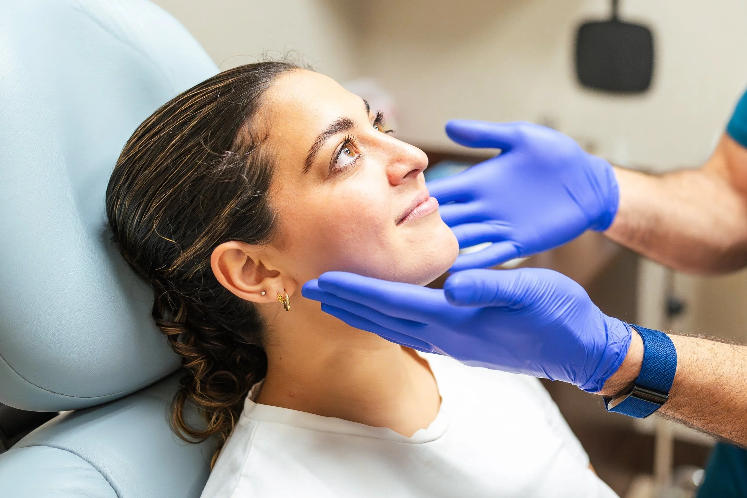 Dermatologist examining a patient's face at Monarch Dermatology in Fort Worth, TX