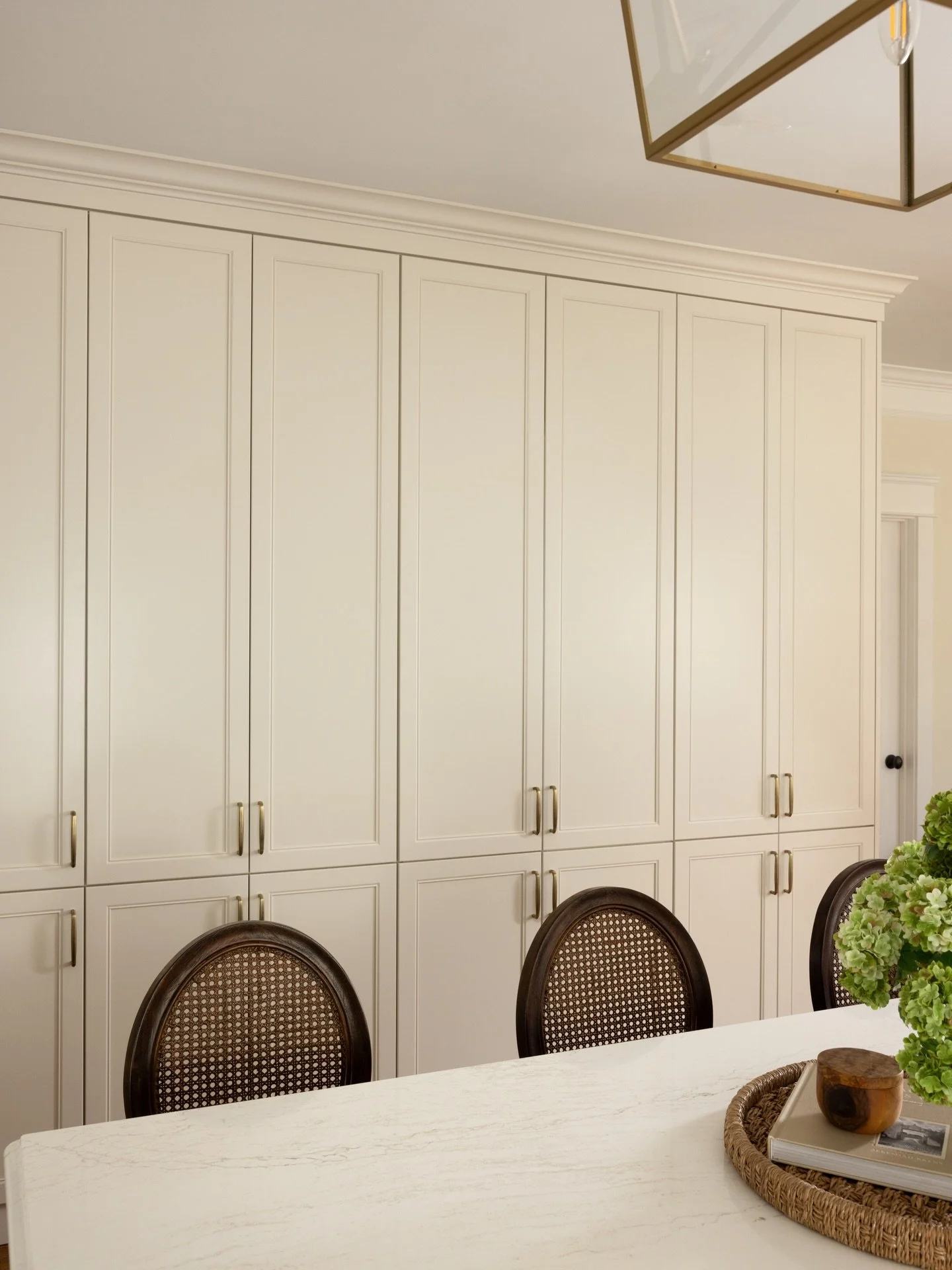 Swipe for a surprise✨ 
What was once a major focal point of the kitchen is now seamlessly concealed. Extra storage was used to hide the laundry entry while improving the function of the kitchen. 

#designideas #hiddencabinet #kitchendesignideas