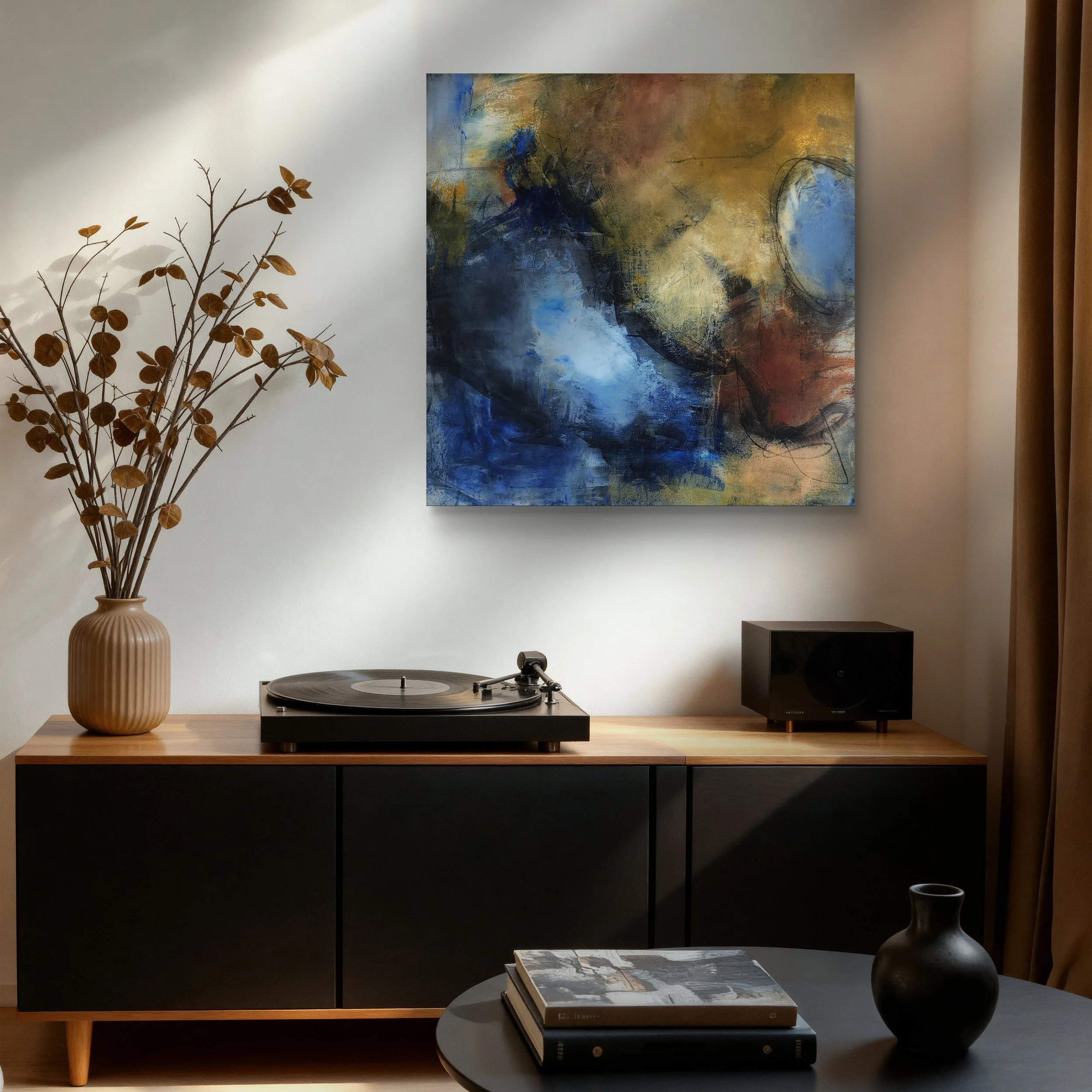 Living room with a black media console, a turntable on the table, a large abstract painting on the wall, a tall vase with dried branches on the left, and books on the table, with a cup and a decorative object on the right.