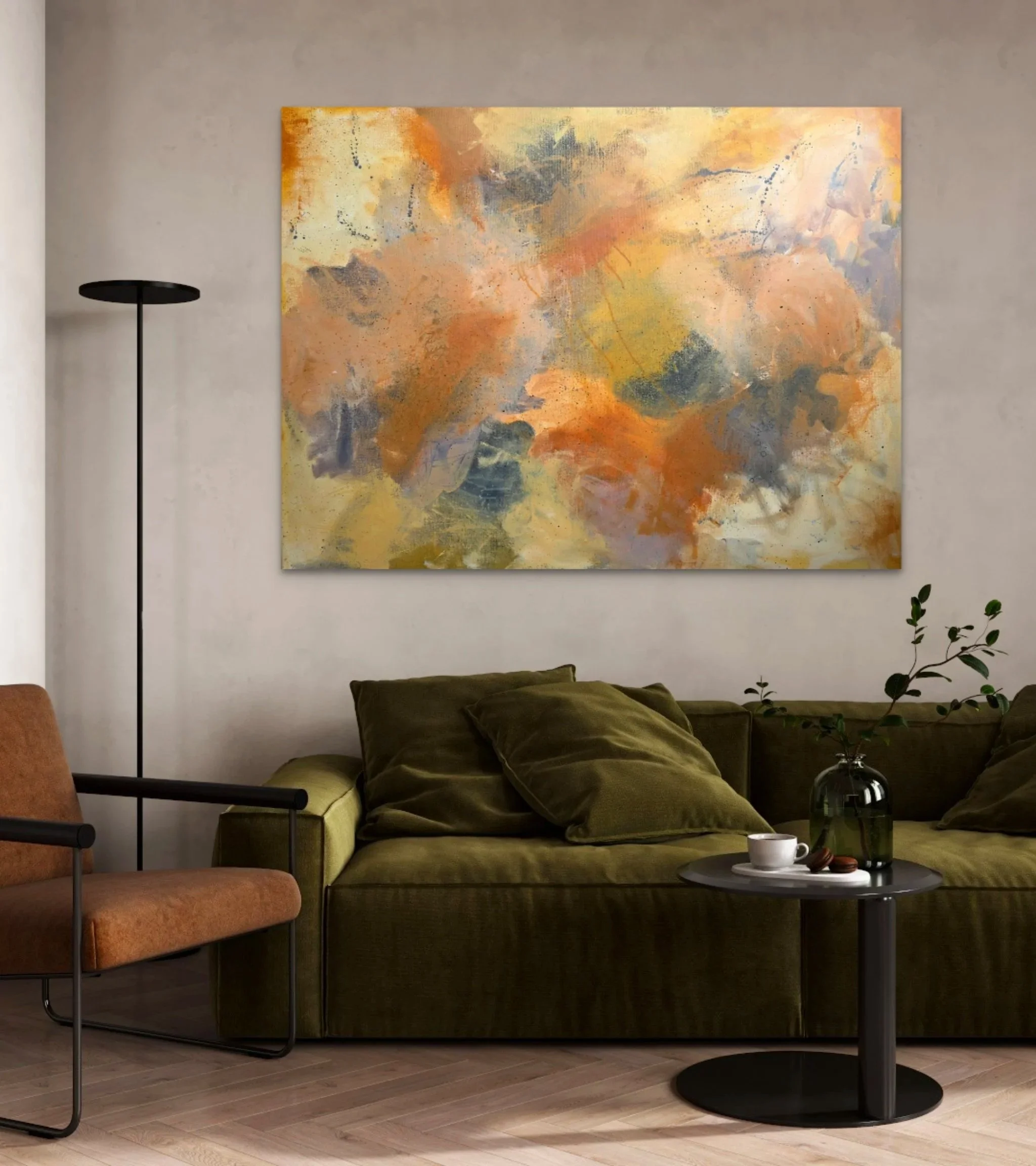 A modern living room with earth-tone furniture, including an olive green sofa with matching pillows, a burnt orange armchair, and a black side table holding a white cup and a small plate. There is a tall black floor lamp on the left and a large abstract painting with warm colors on the wall behind the sofa. Decorative branches with leaves are on the right side of the image.