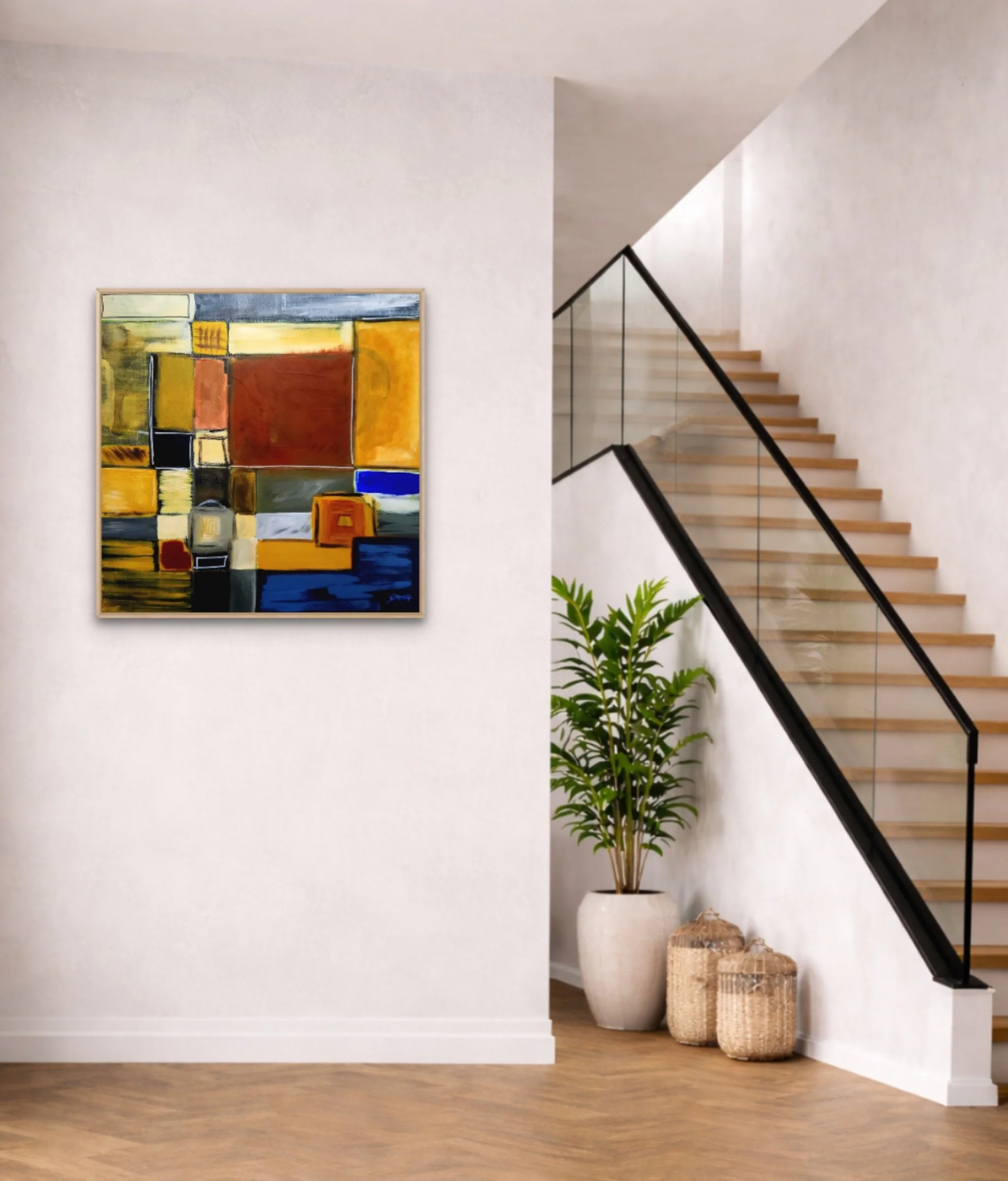 Modern interior with abstract colorful painting on white wall, potted plant, woven baskets, wood flooring, and staircase with glass railing and wooden steps.