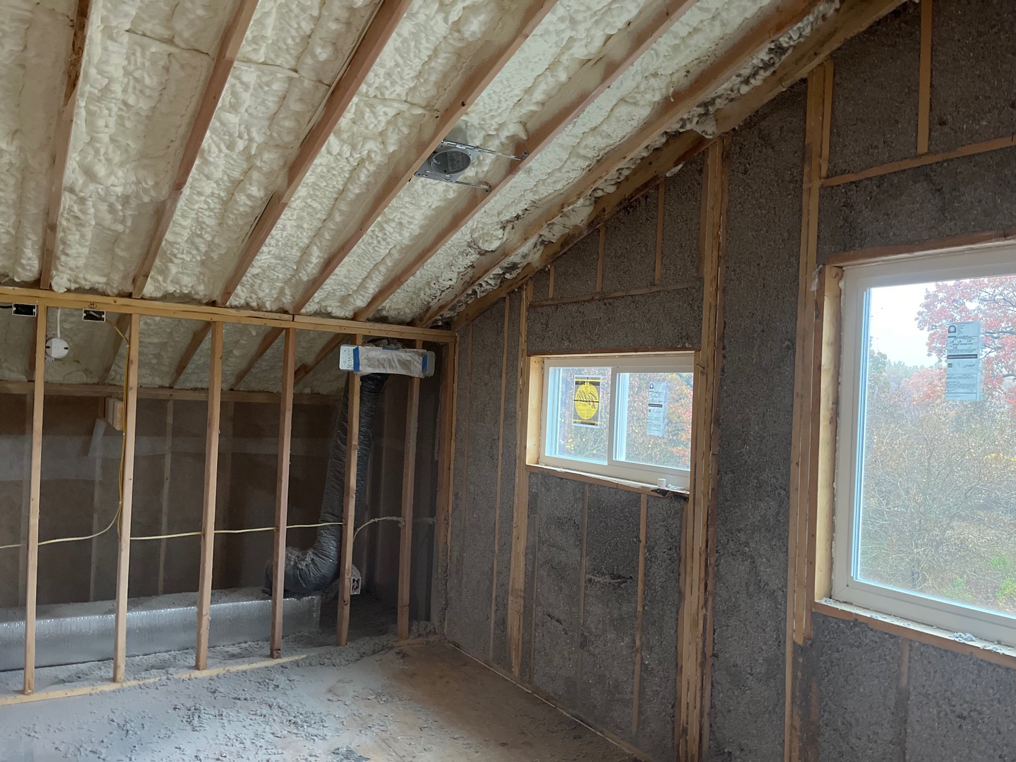 Get a custom insulation package that maximizes your energy savings, AND meets your budget.

In this project, we spray foam insulated the roof deck, and installed a wall-sprayed cellulose for the exterior walls of this new build. This was a great way 