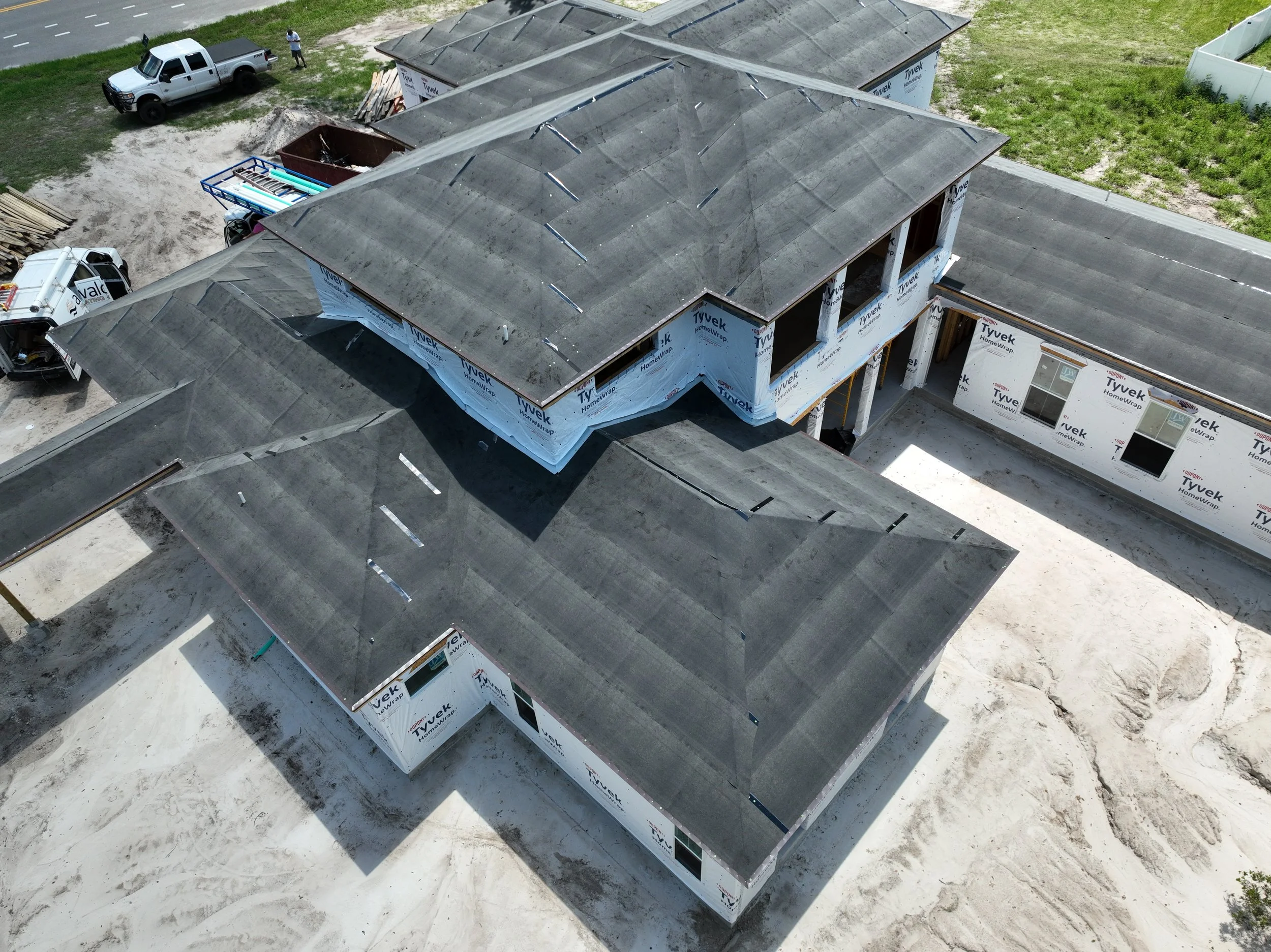 This aerial view captures the rear design and expansive roofline of a luxury custom home under construction off State Road 16 near SilverLeaf in St. Augustine, Florida. Elite Construction of JAX builds custom homes throughout St. Augustine, Jacksonvi