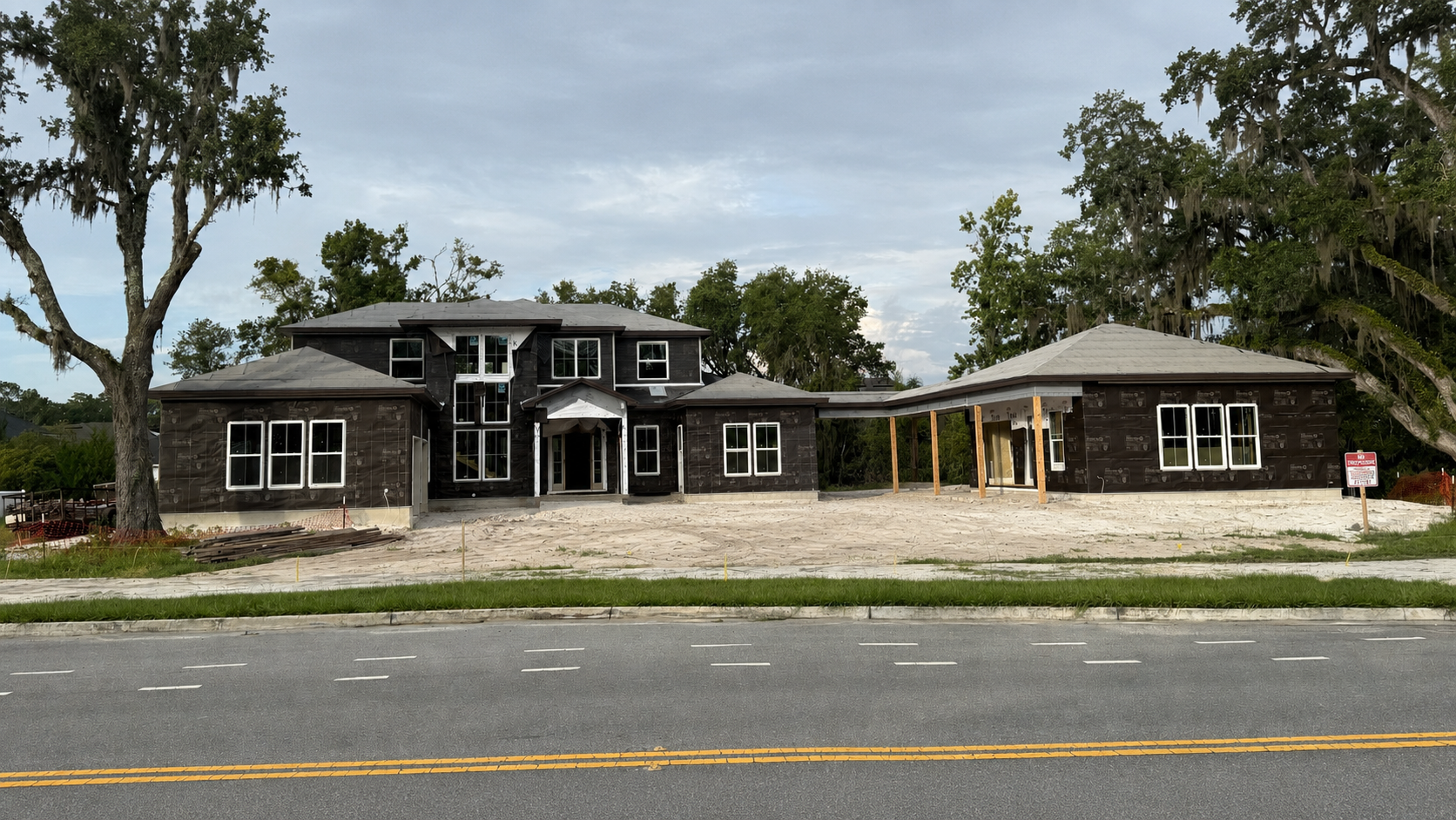 Exterior weatherproofing and window installation reveal the impressive front elevation of this luxury custom home off State Road 16 near SilverLeaf in St. Augustine, Florida. Elite Construction of JAX builds distinctive custom homes throughout St. Au