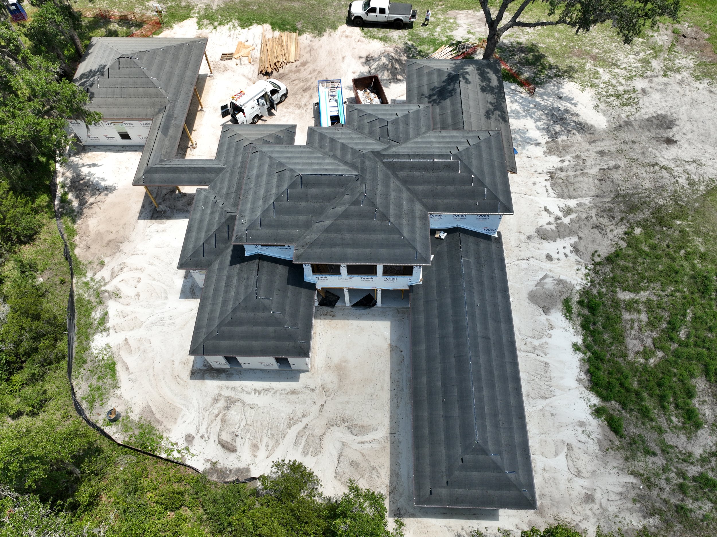 A bird’s-eye view showcases the expansive footprint and detailed roof design of this luxury custom home off State Road 16 near SilverLeaf in St. Augustine, Florida. Elite Construction of JAX builds distinctive custom homes throughout St. Augustine, J