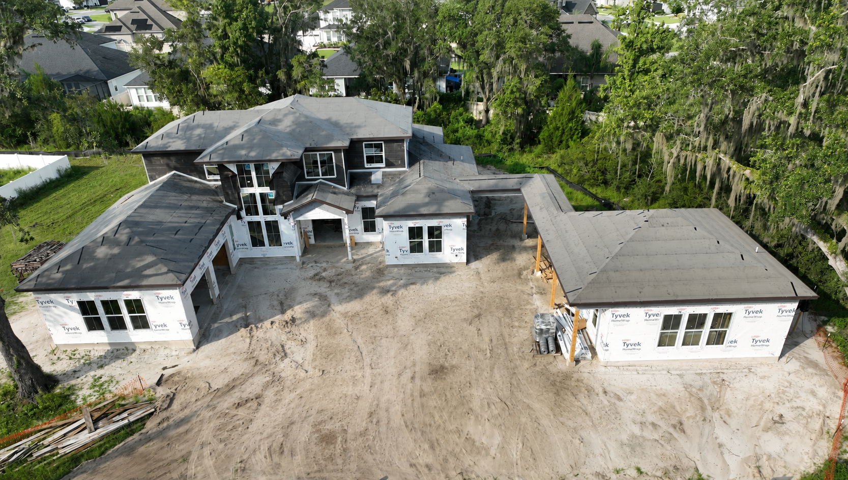An aerial view highlights the size and distinctive layout of this luxury custom home under construction off State Road 16 near SilverLeaf in St. Augustine, Florida. Elite Construction of JAX builds exceptional custom homes throughout St. Augustine, J