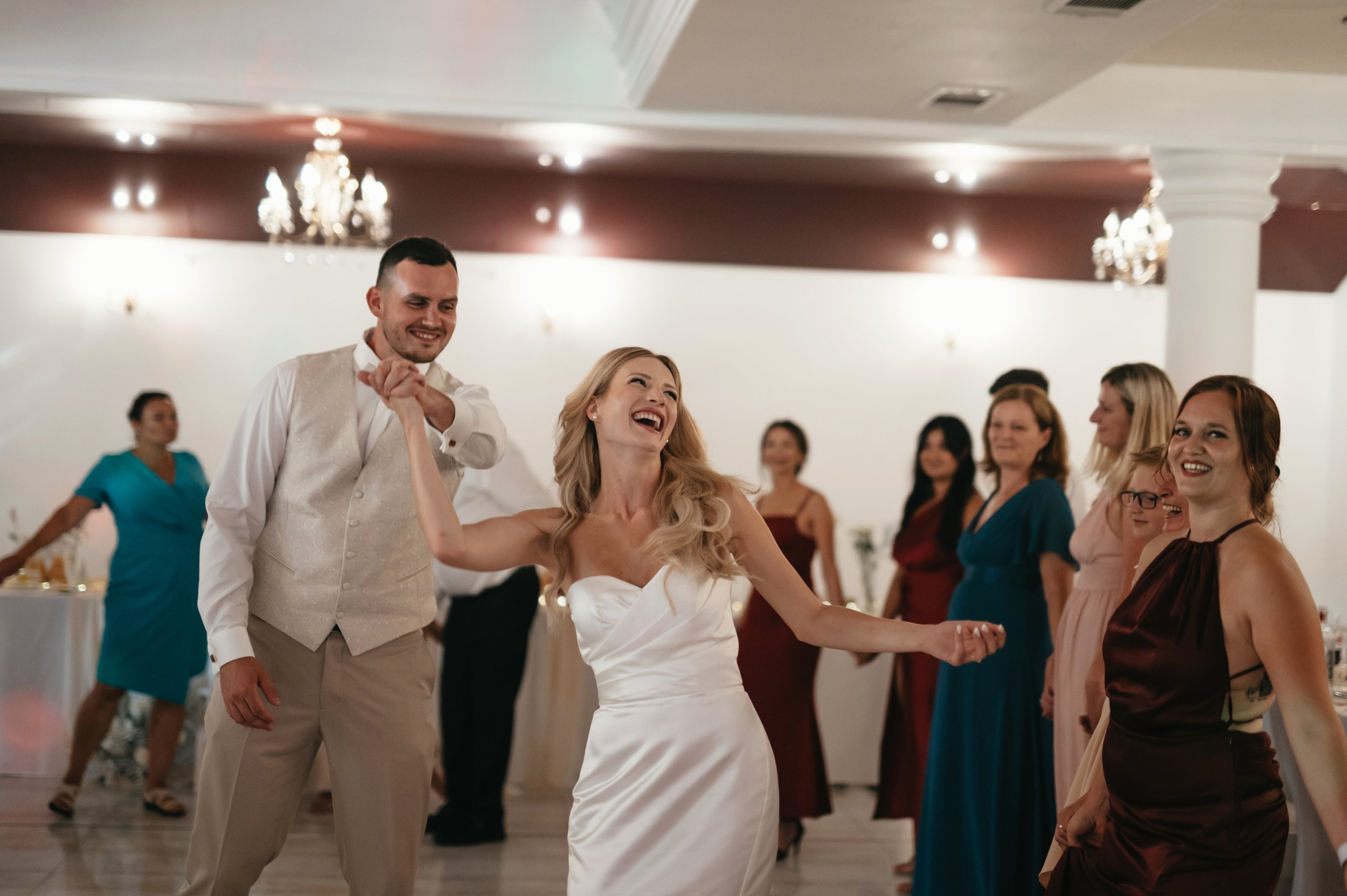 	
Lidé tančí a oslavují na svatební hostině.