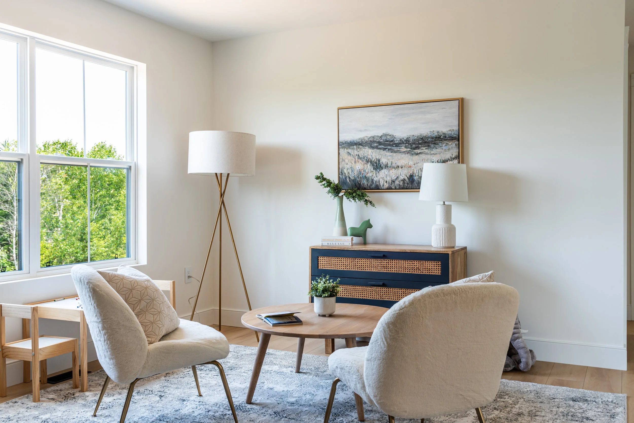 Professionally staged sitting area with floor lamp, table lamp, layered lighting, and large windows — home staging Halifax for real estate photography
