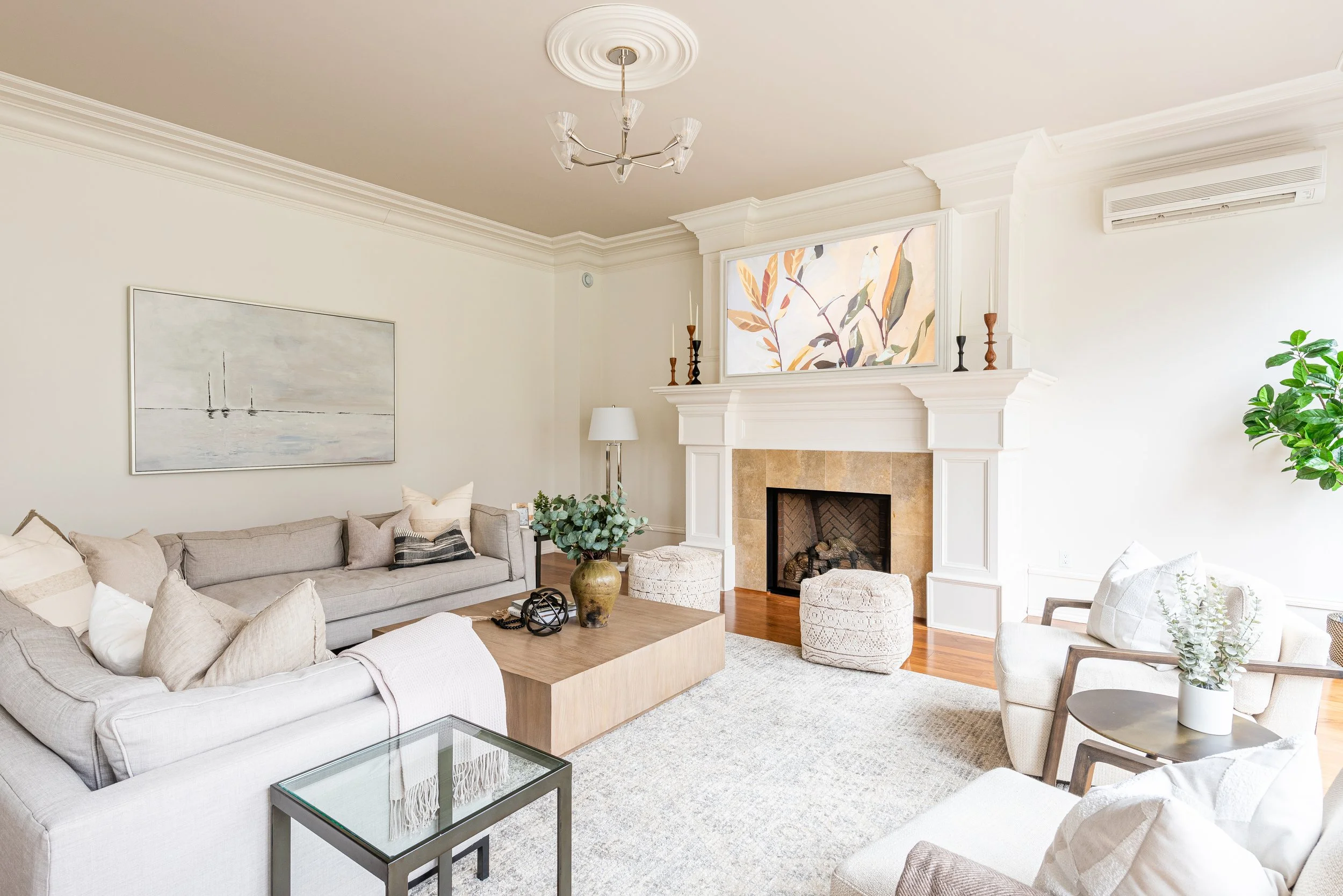 Staged living room with fireplace, neutral tones, layered lamps, and warm lighting — Halifax home staging company Charlotte Interiors